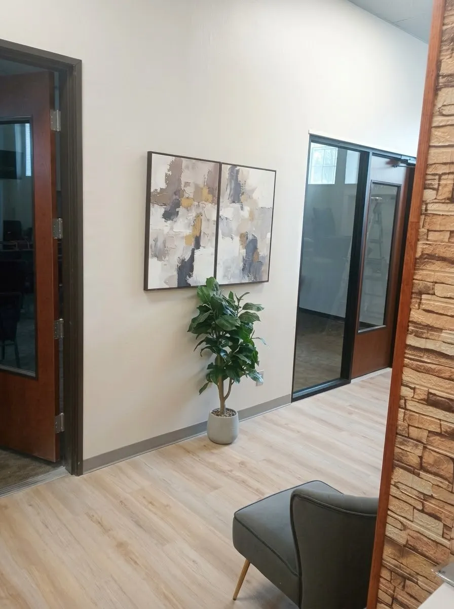 Wood-finish flooring throughout, bright white walls, and a modern trim package