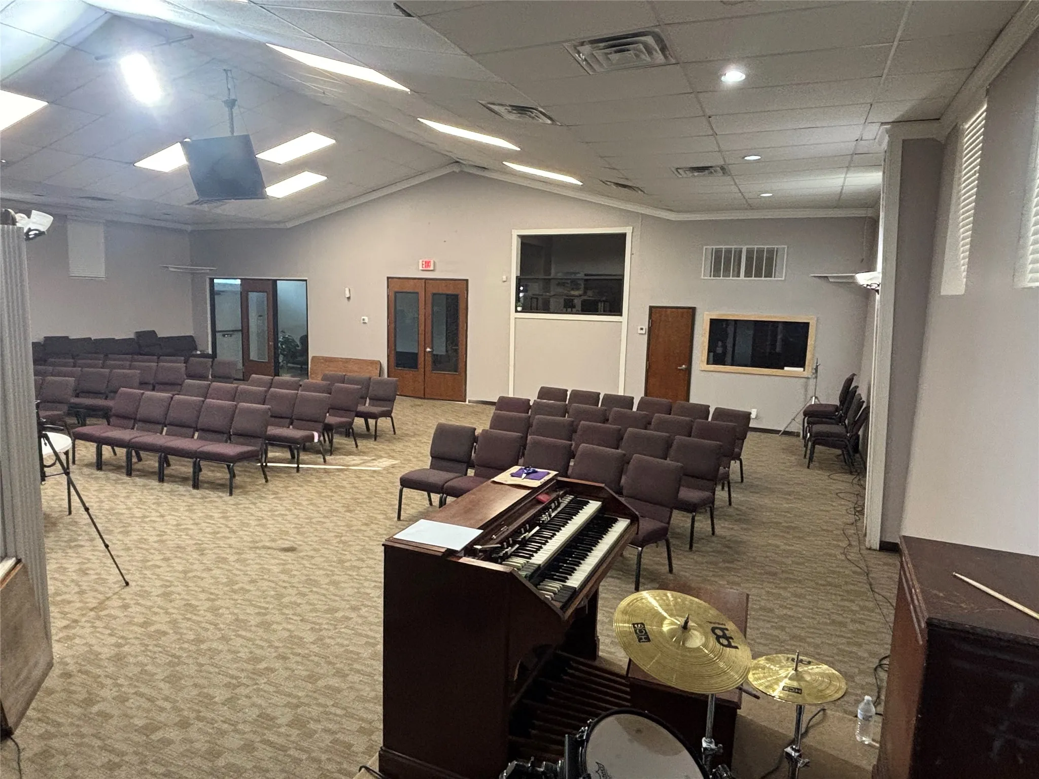 Carpeted main room with a vaulted ceiling and skylights