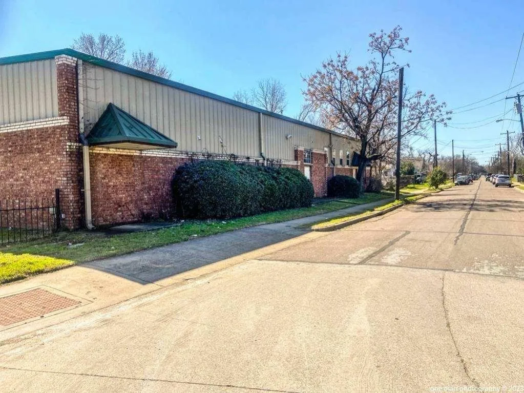 Brick and metal siding exterior with a green awning, Side street parking