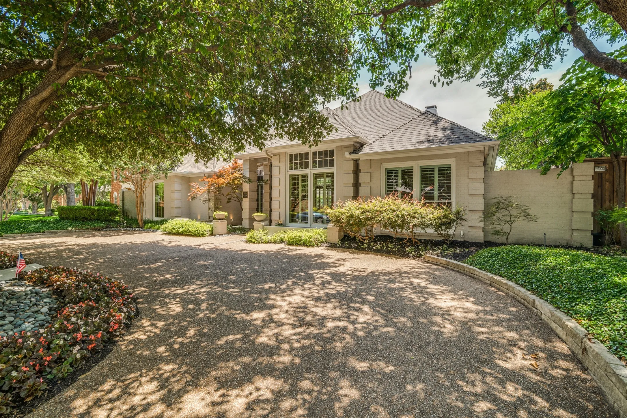 Outstanding first impression with wide circular drive and pretty, colorful landscaping.