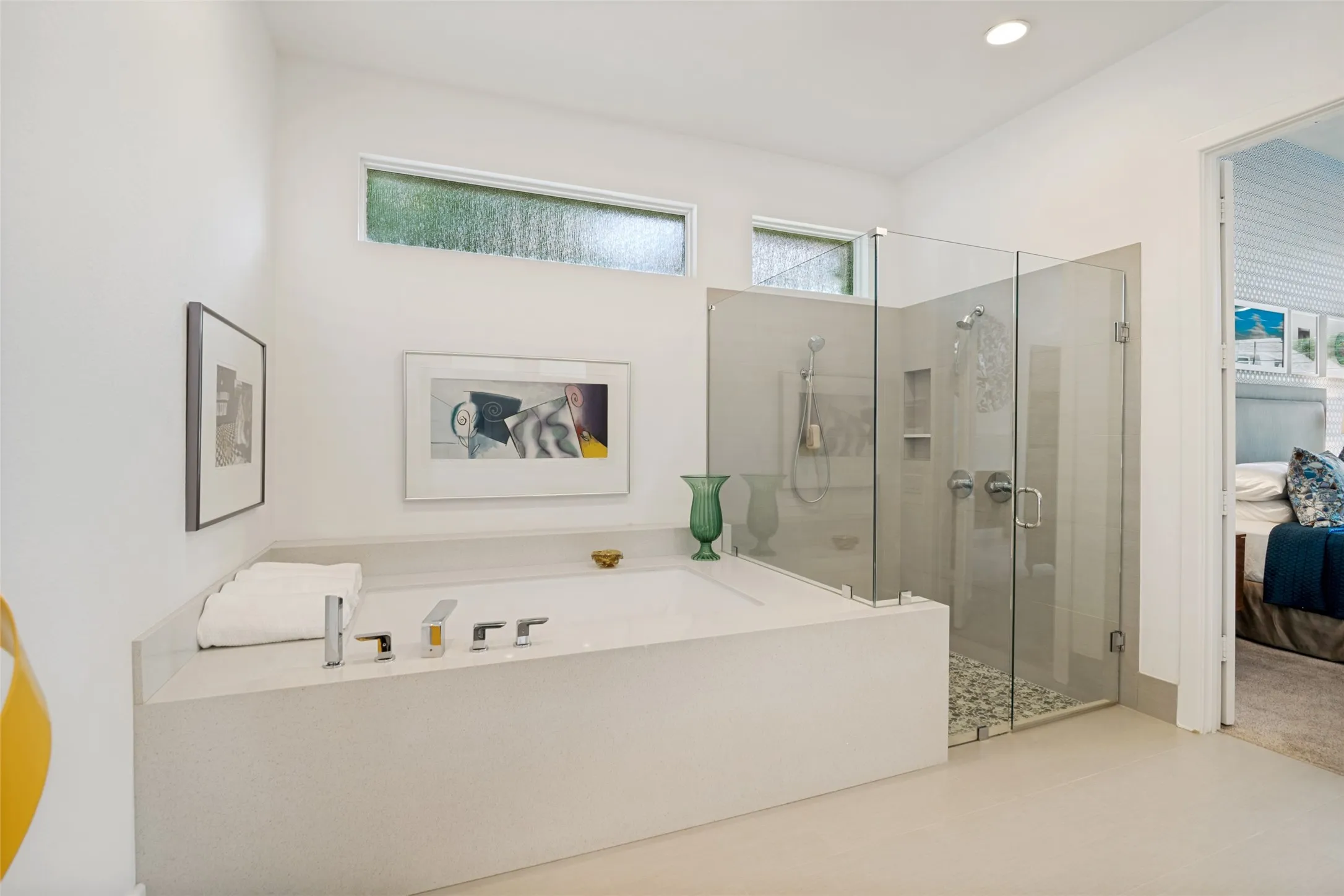 Large soaking tub with room for bath items and glass surround shower.