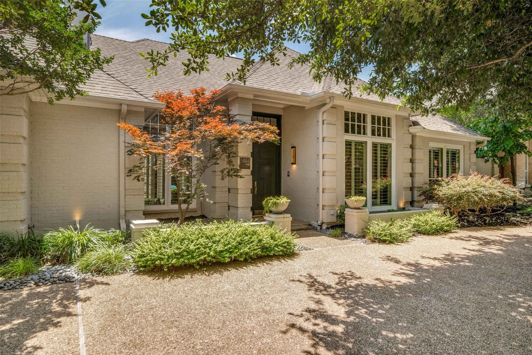 Gorgeous Japanese Maple is a standout pop of color against the light brick exterior.