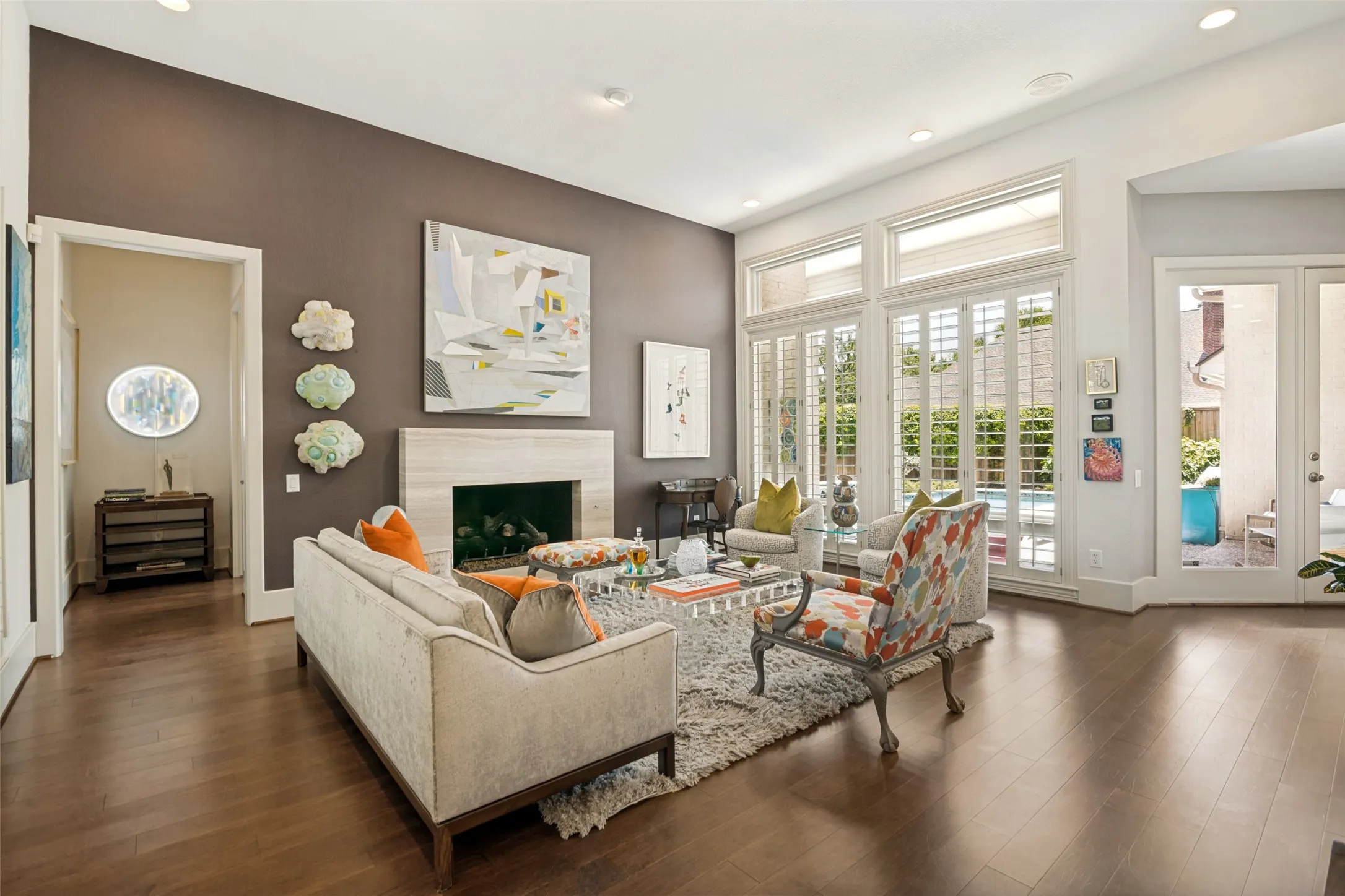 The fireplace was remodeled for a clean, modern look. Hallway on the left leads to the primary suite