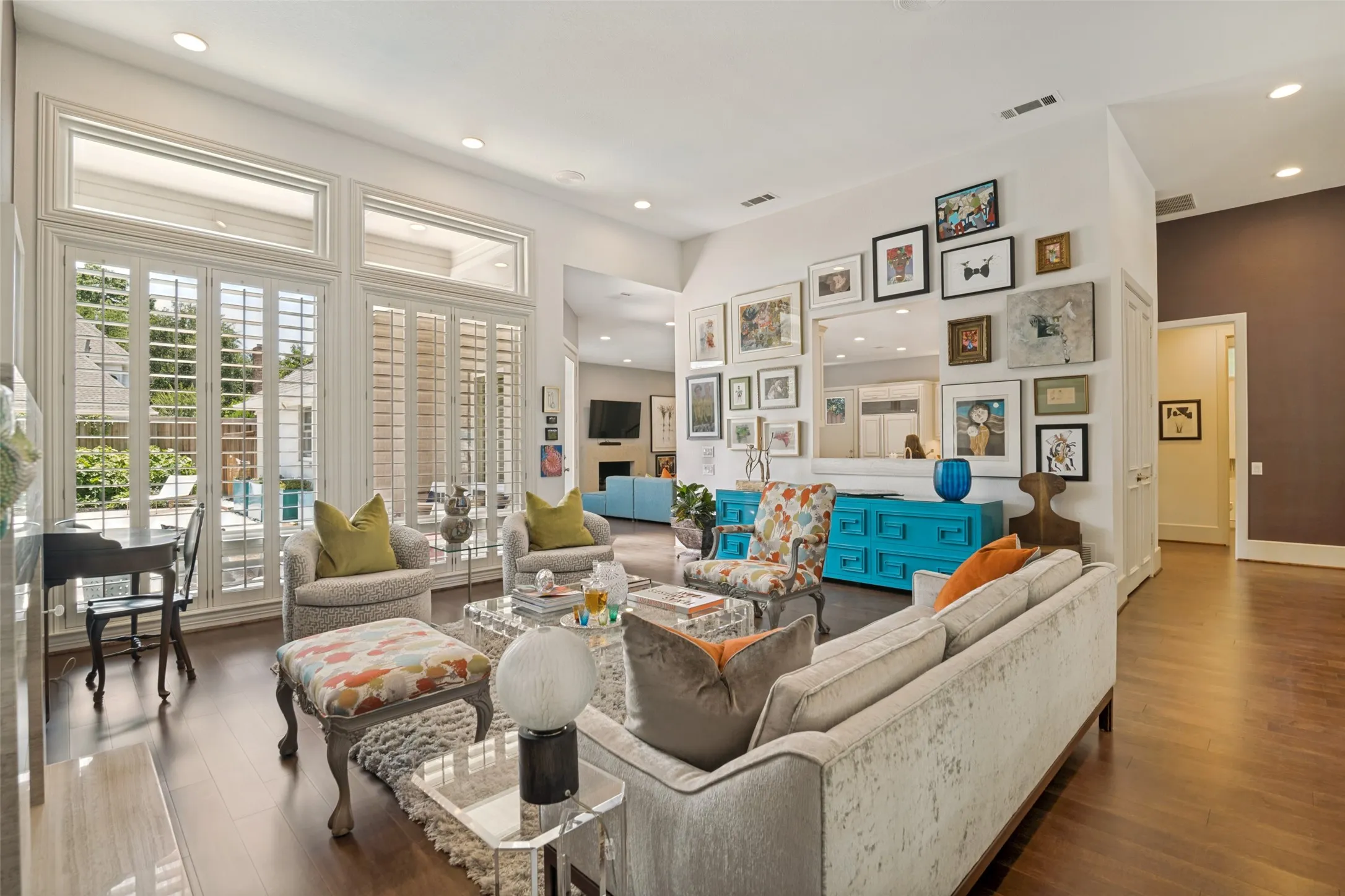 View of the living room from the front entry is a showstopper! Walls of windows with pool/patio views and abundant natural light wrap around to the family room! 12 foot ceilings!
