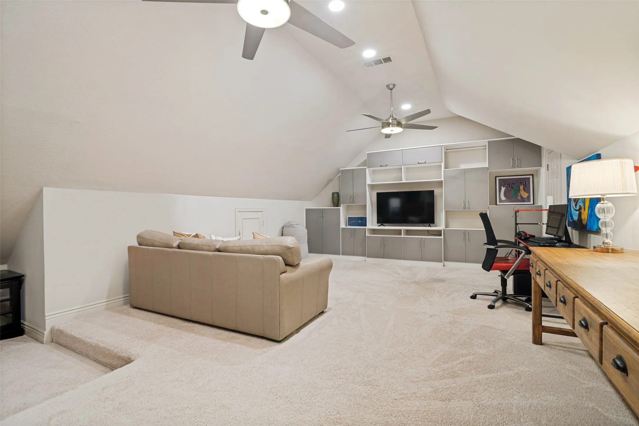 Huge upstairs game room with built ins for storage and display on two walls!