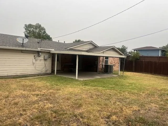 Spacious backyard with mature landscaping and established lawn