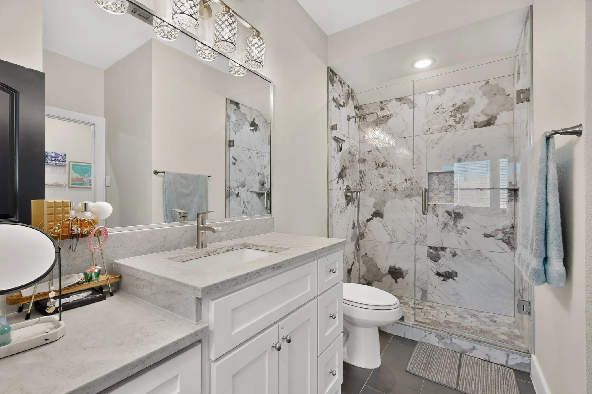 White vanity with an integrated sink and light-toned countertop