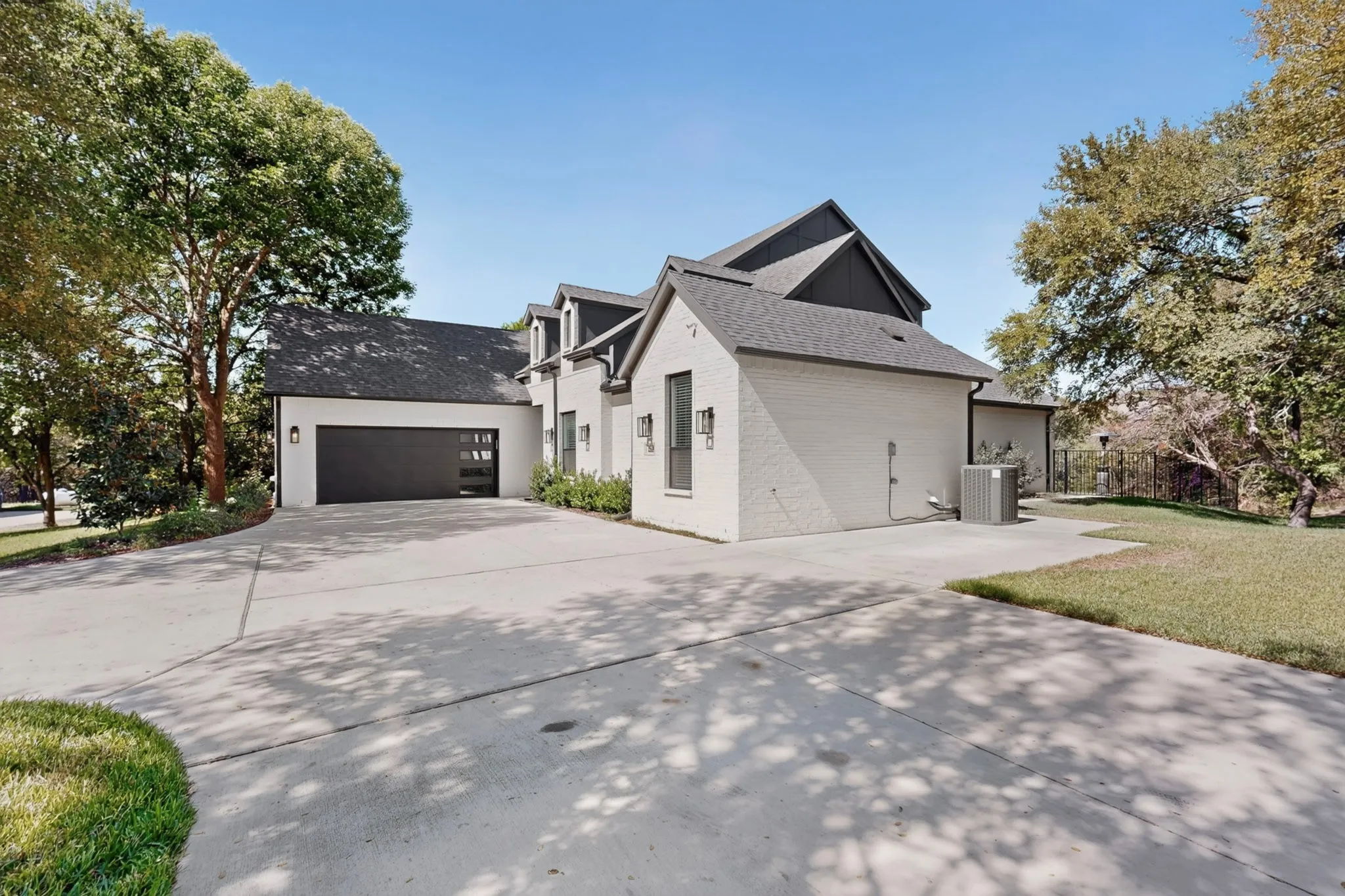 White brick exterior with dark trim and roof