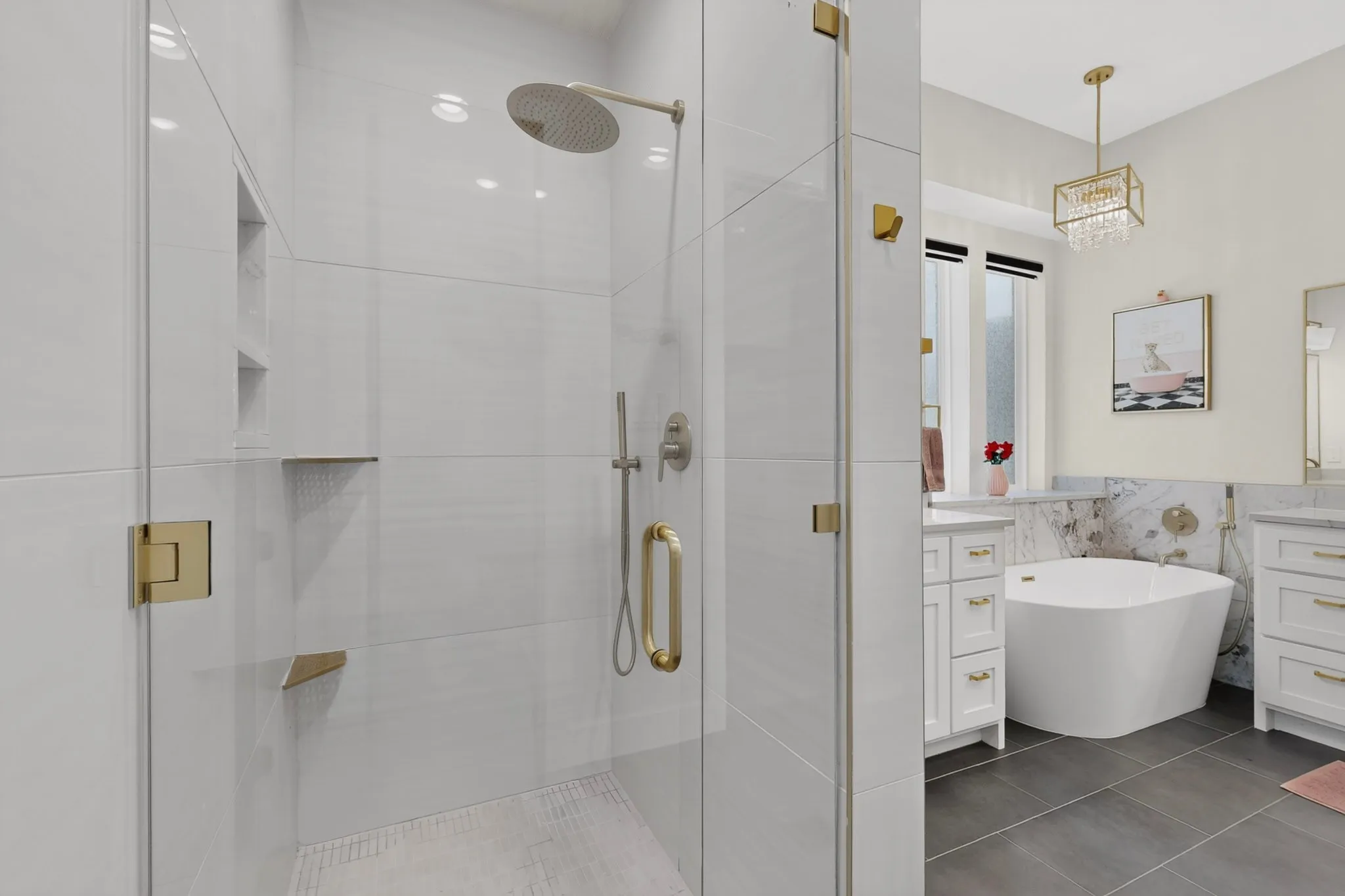 Glass-enclosed shower with a rainfall showerhead and gold-tone fixtures