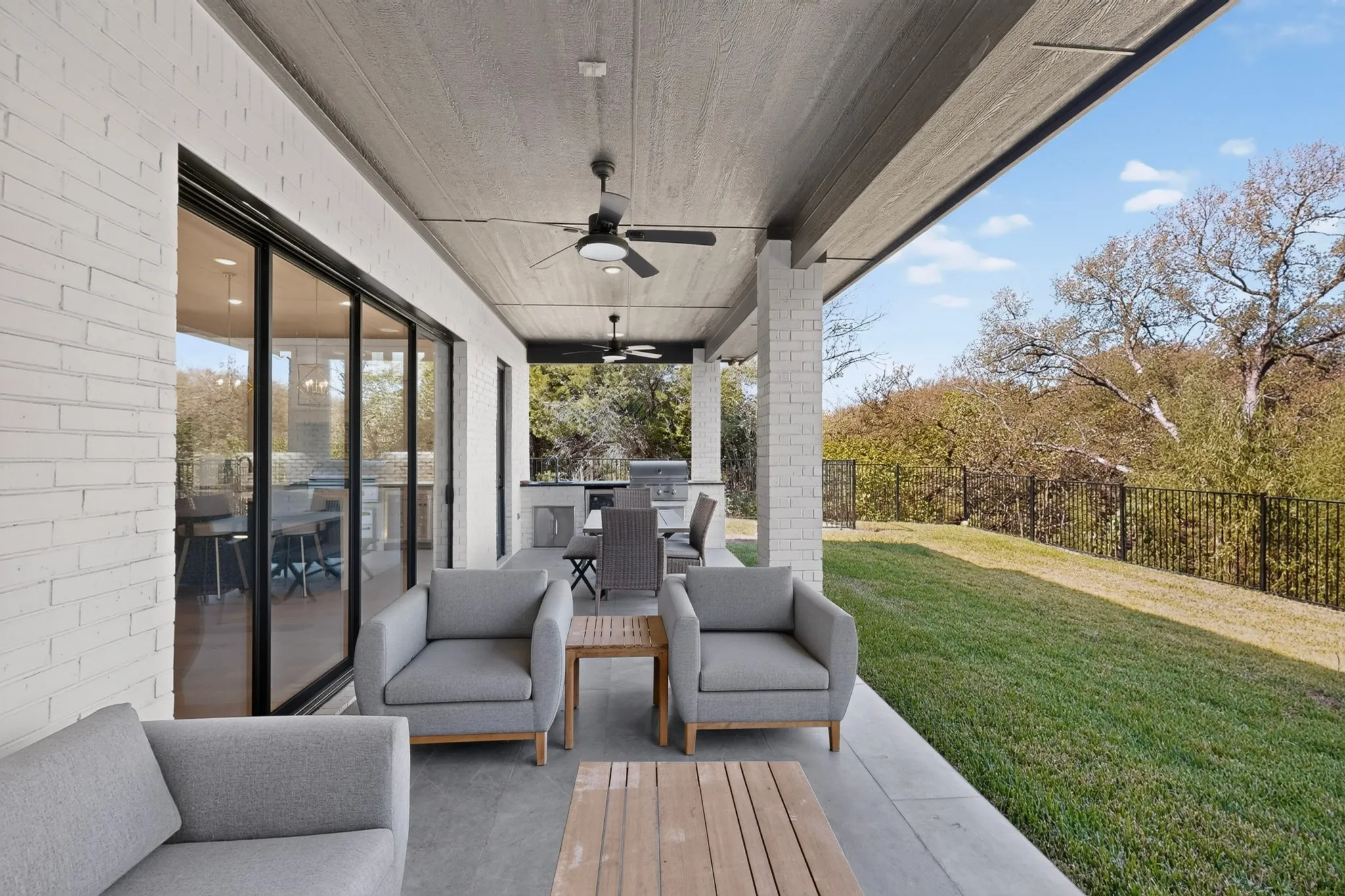 Expansive covered patio with recessed lighting and ceiling fans