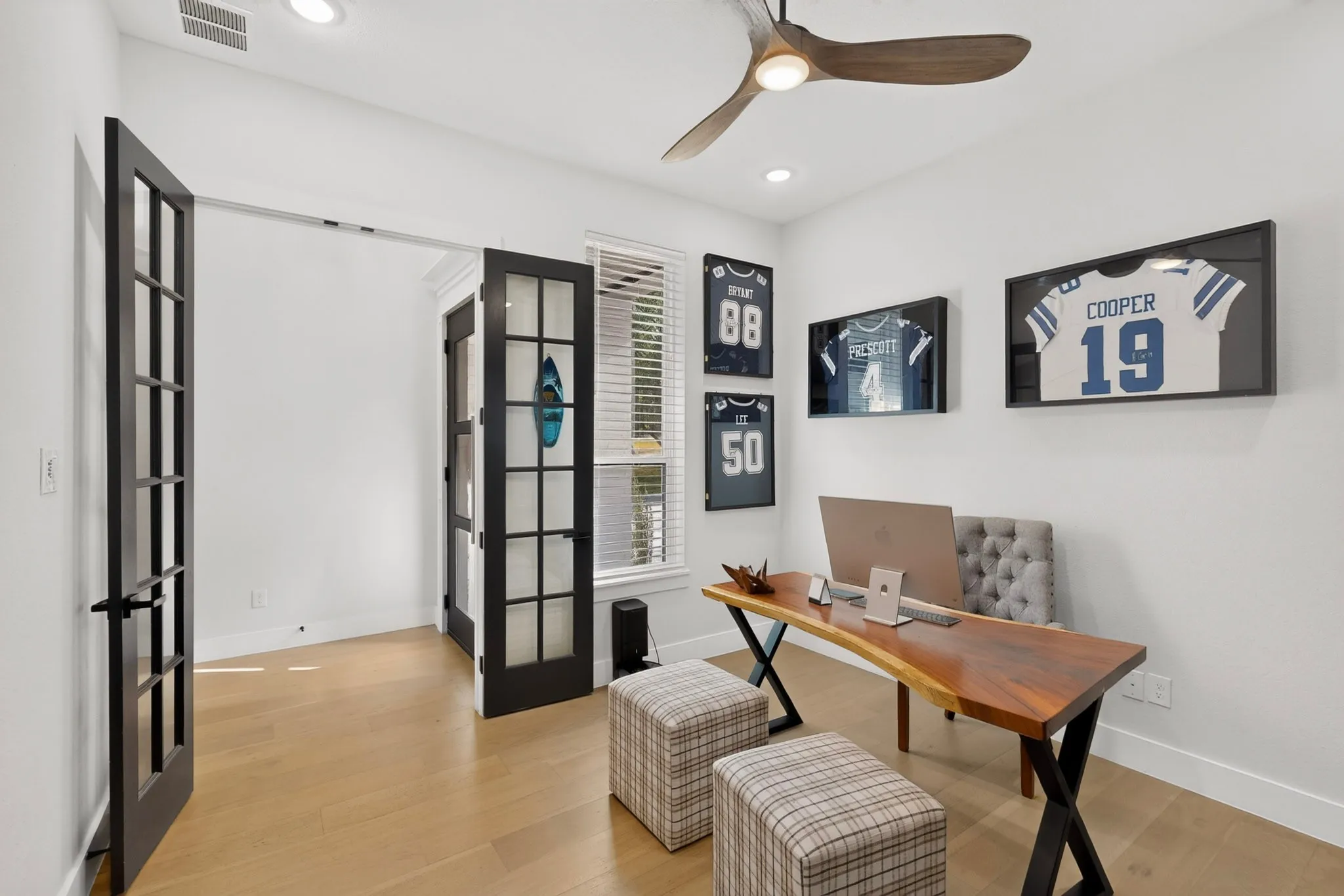 Light wood-finish flooring with white walls and recessed lighting