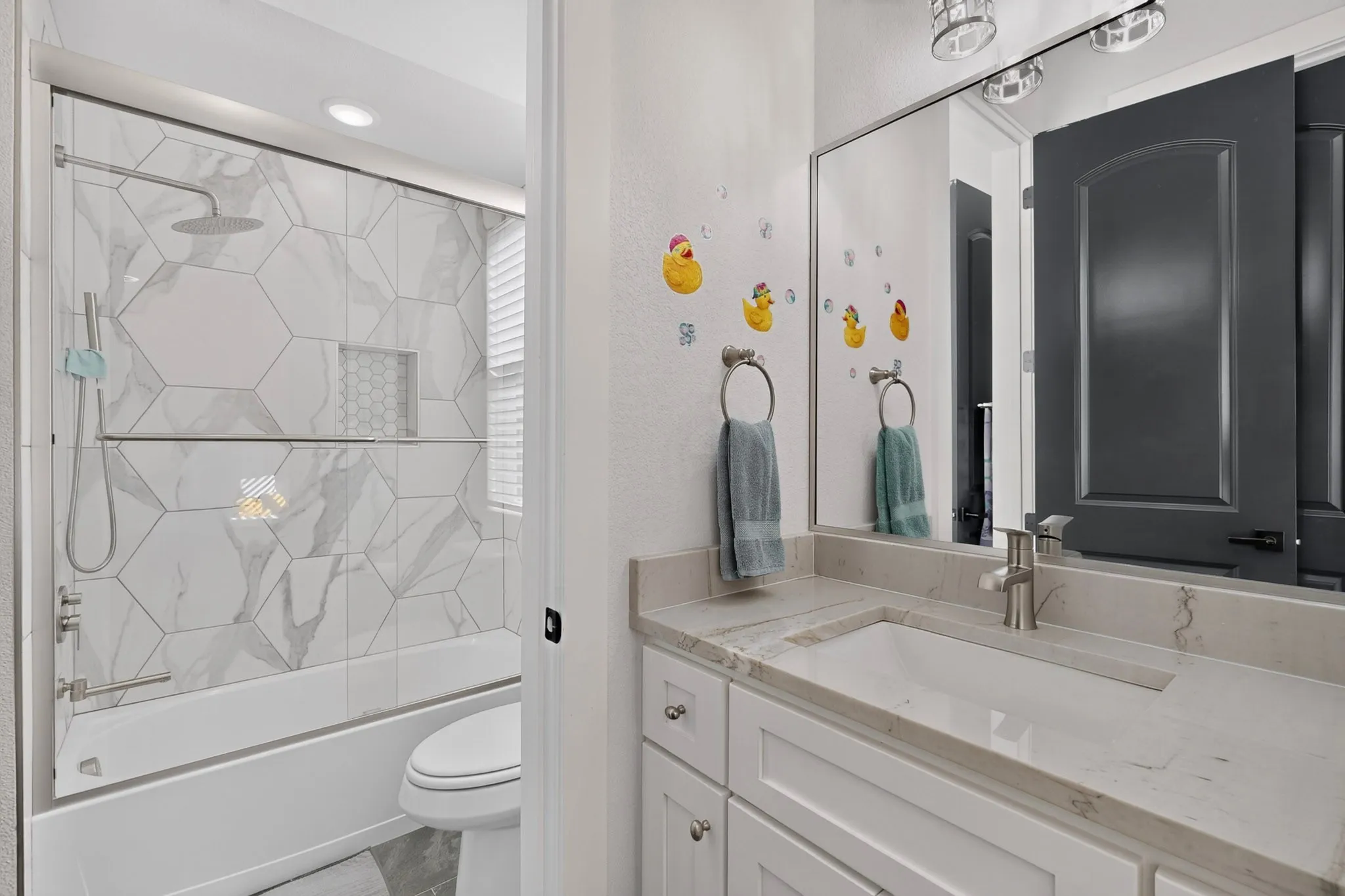 White vanity with an integrated rectangular sink and light-toned countertop