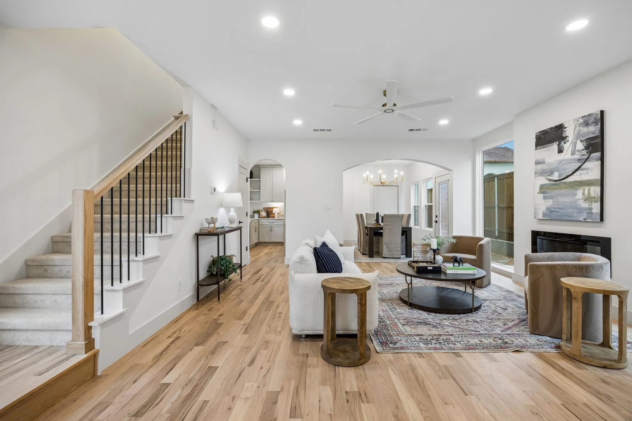 Wood-finish flooring throughout the living area, recessed lighting, ceiling fan and an electric fireplace