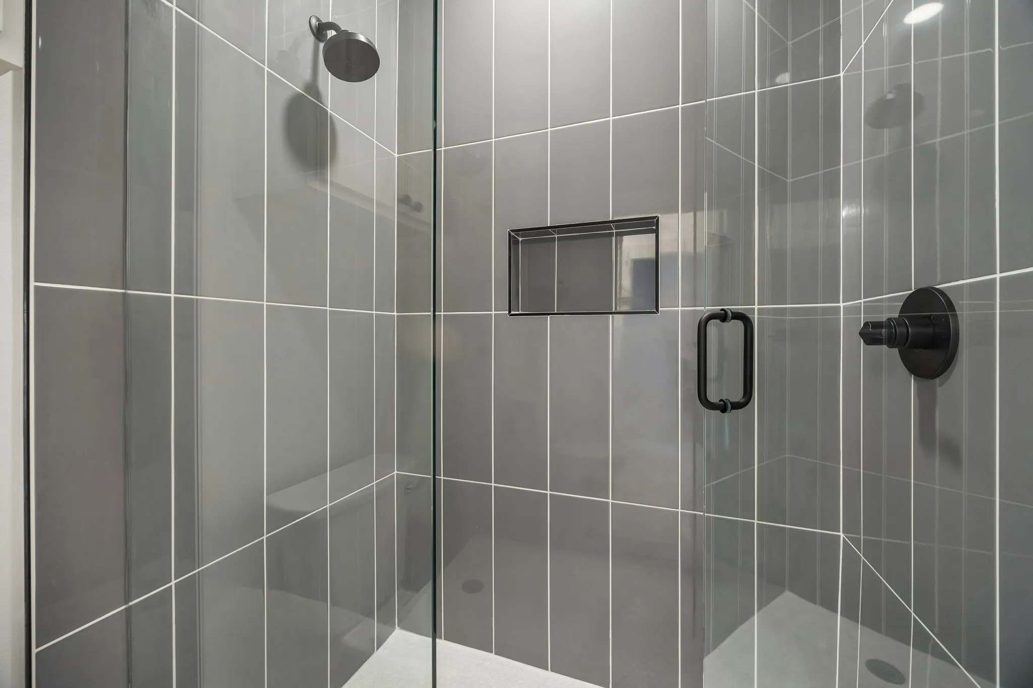 Frameless glass shower in the jack and jill bathroom