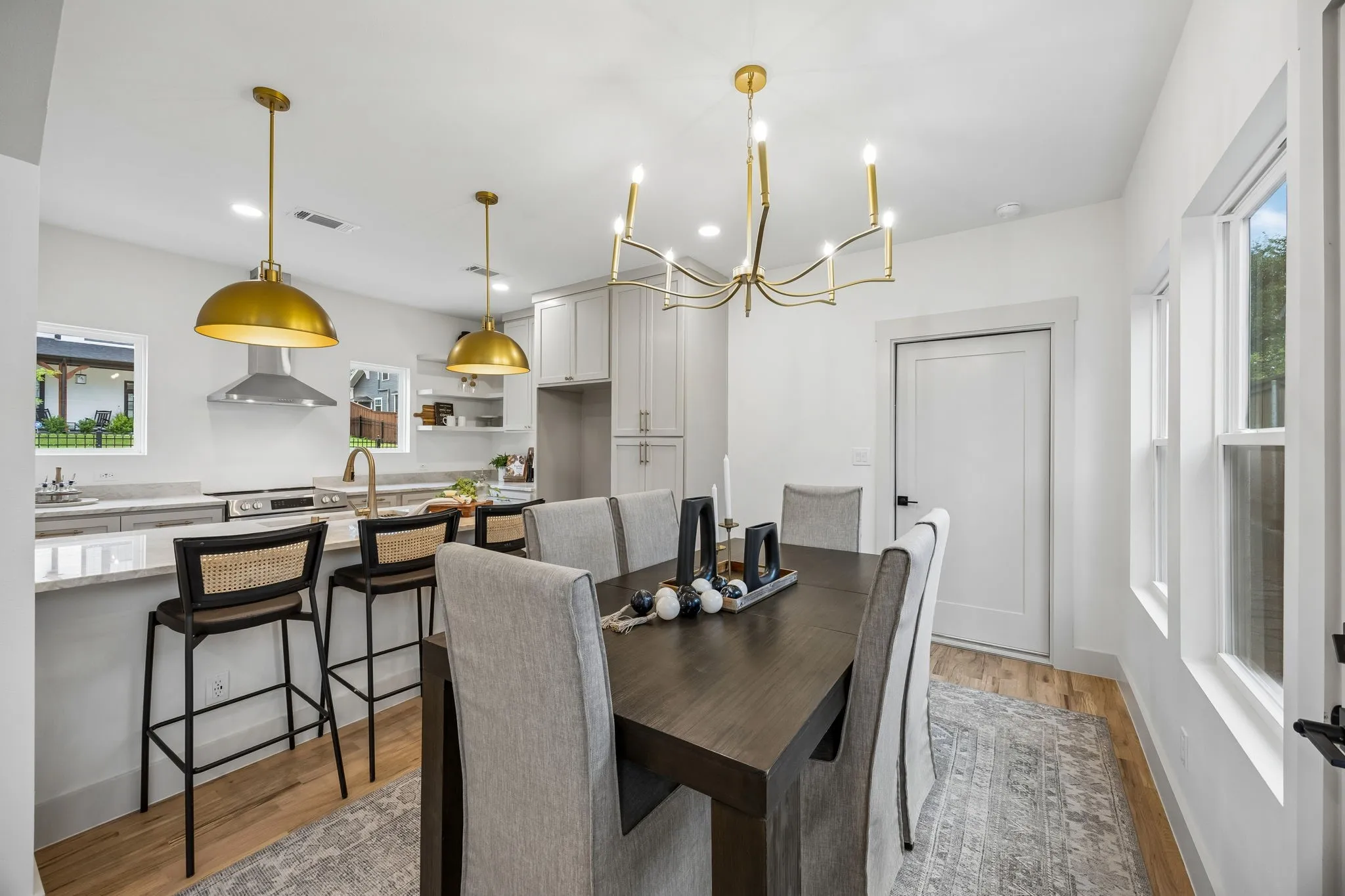 Open-concept kitchen and dining area featuring modern lighting.