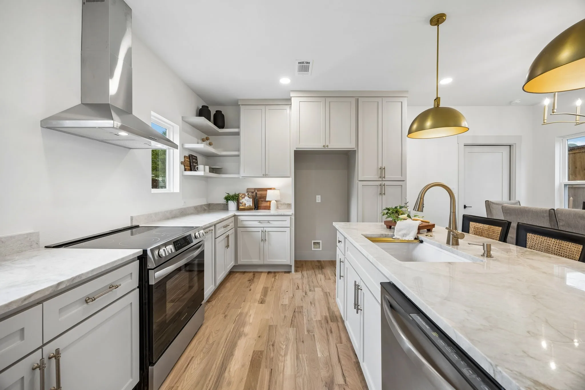The stainless steel appliances include a dishwasher, electric range and commercial grade vent
