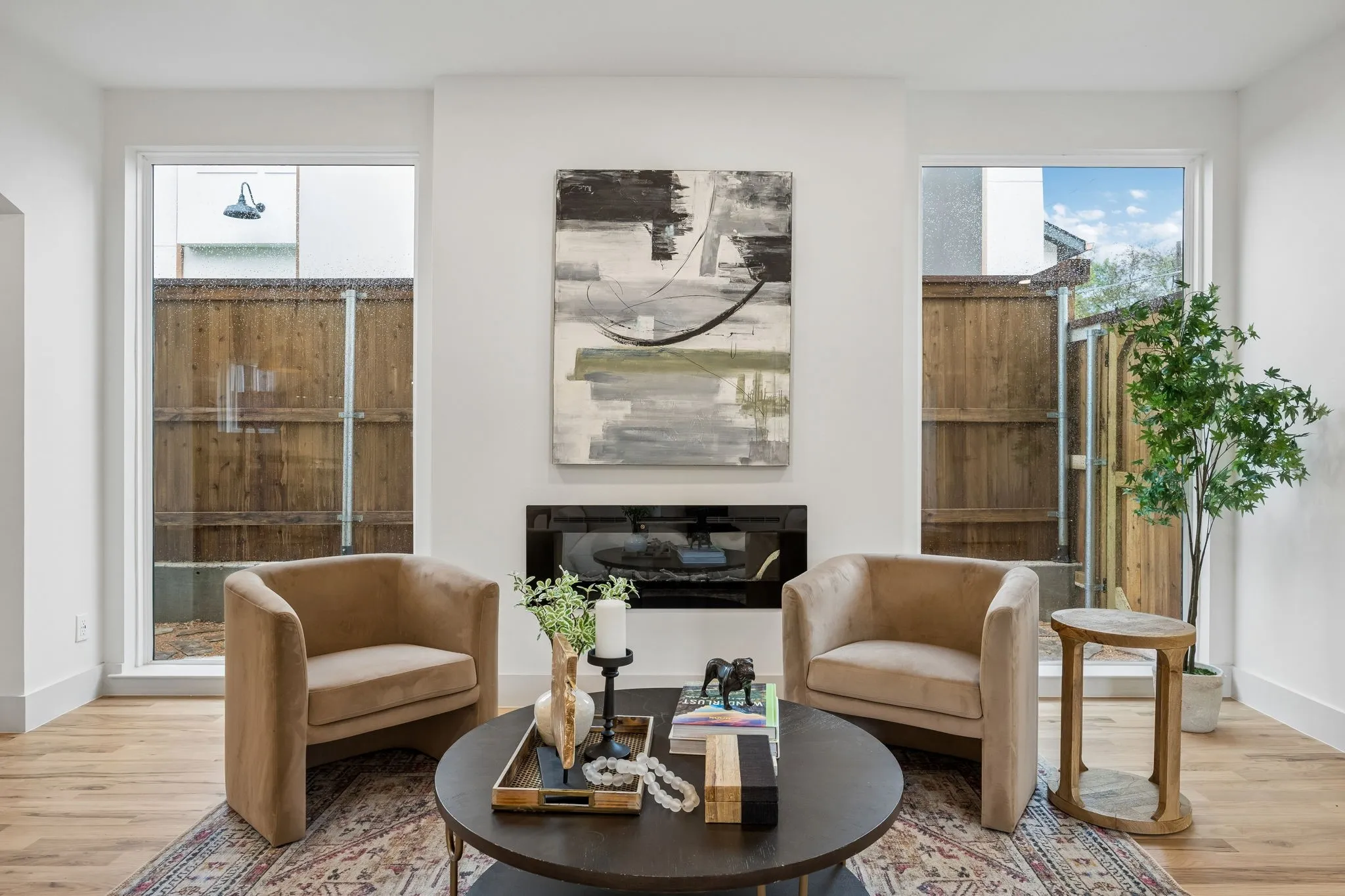 The large picture windows frame the electric fireplace