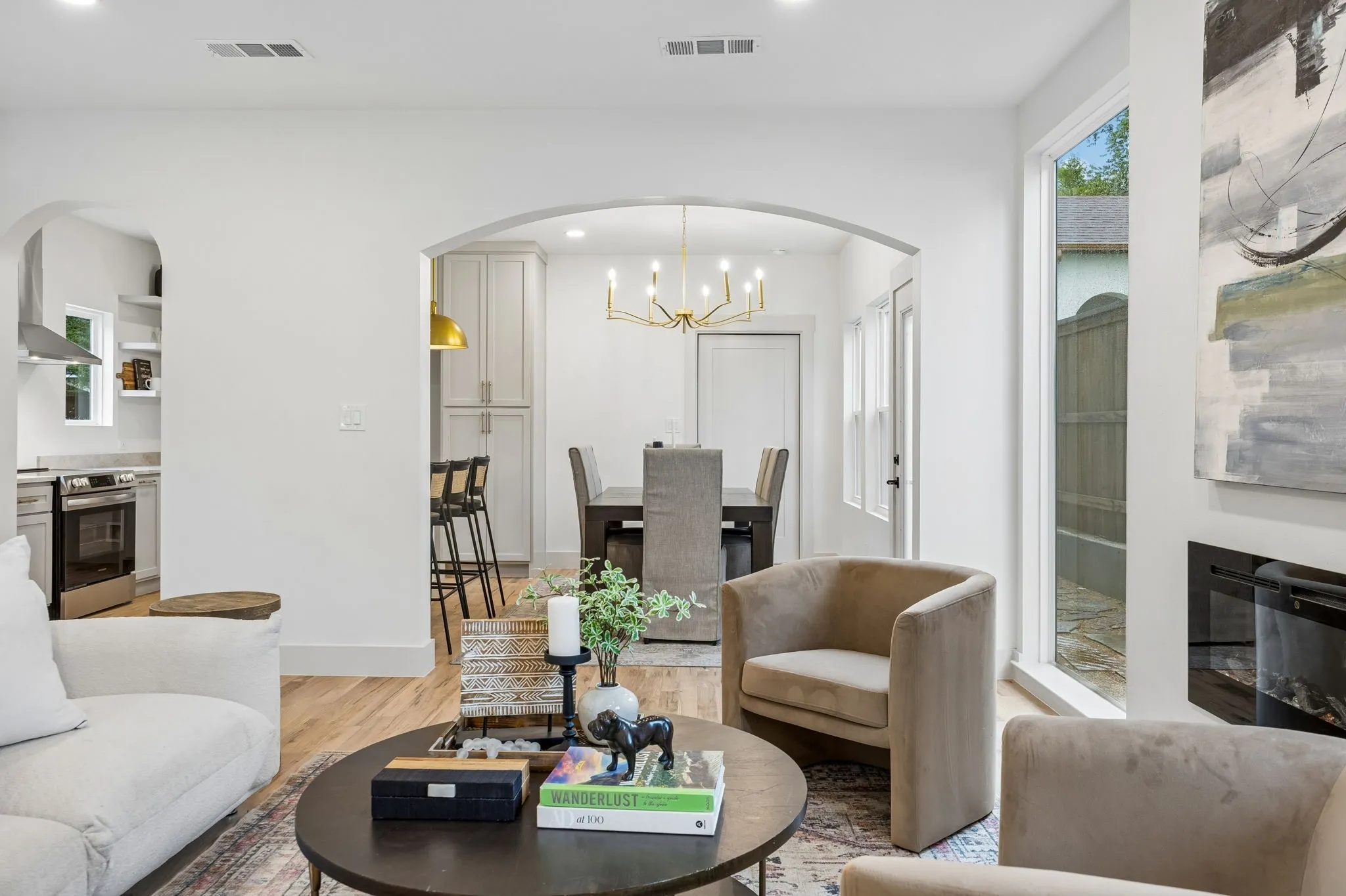 Open-concept living area looking into the eat in kitchen