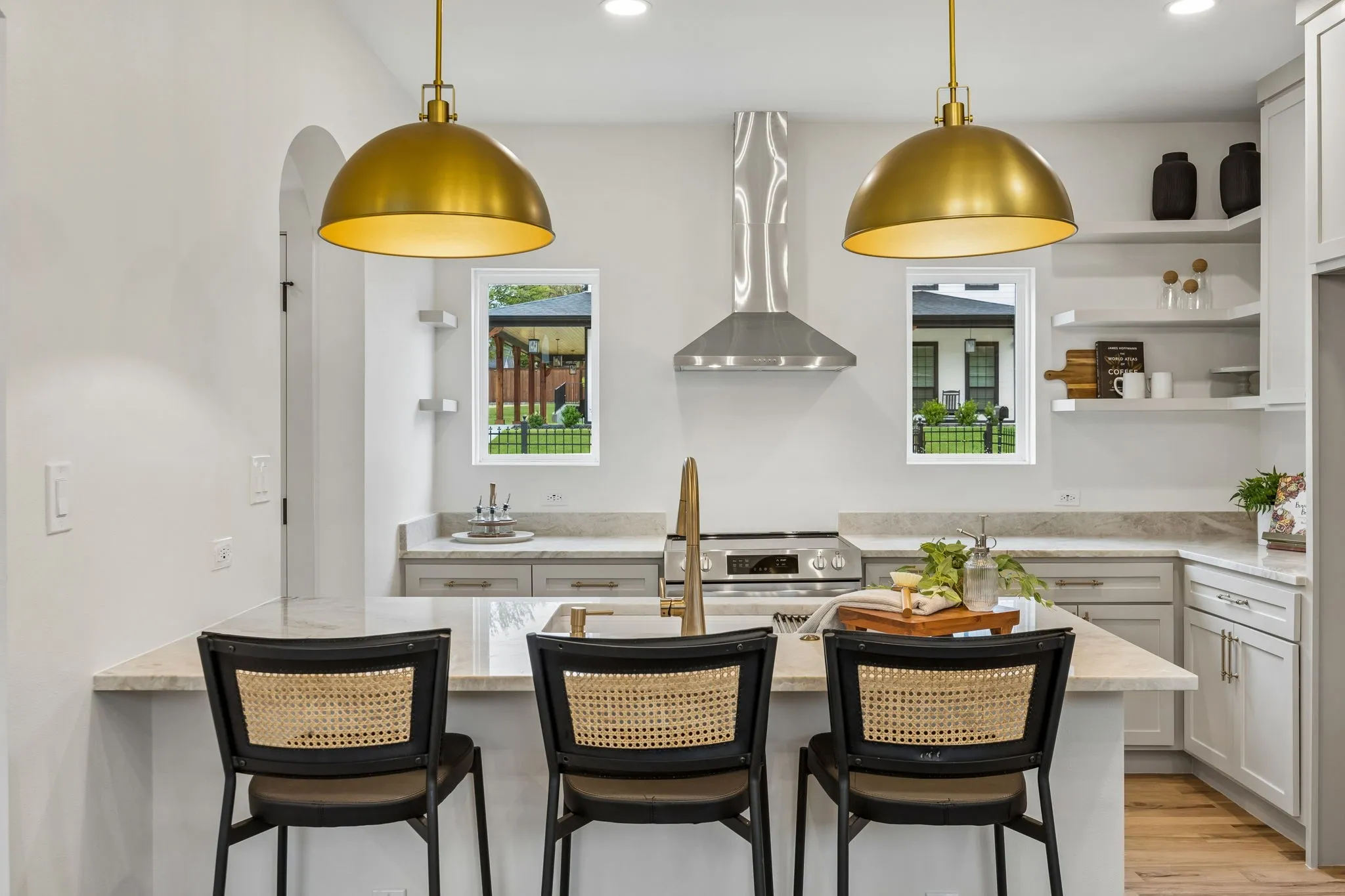 Kitchen featuring gold-tone pendant lighting and open upper shelves