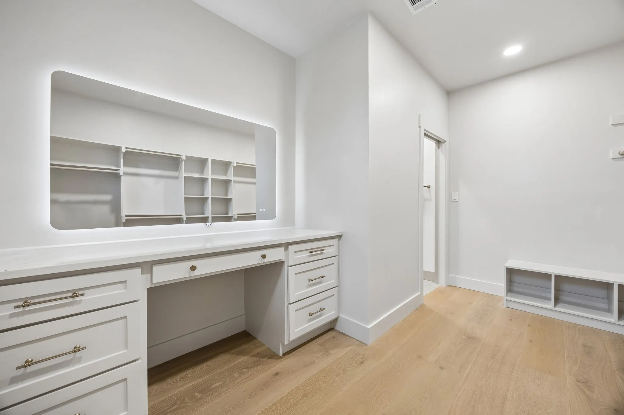 The walk-in primary closet features a vanity