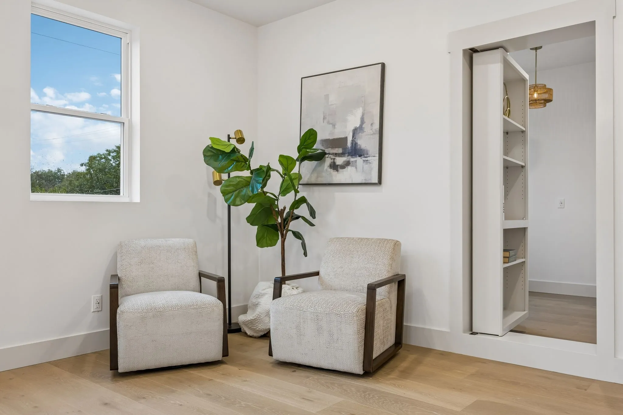 The sitting area of the primary bedroom with the opening to the hidden room.