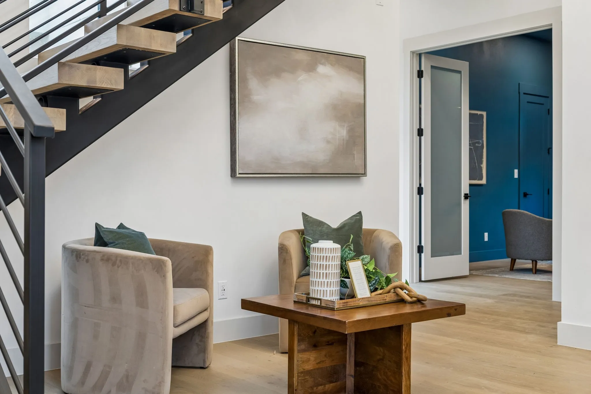 Floating staircase with dark metal railings
