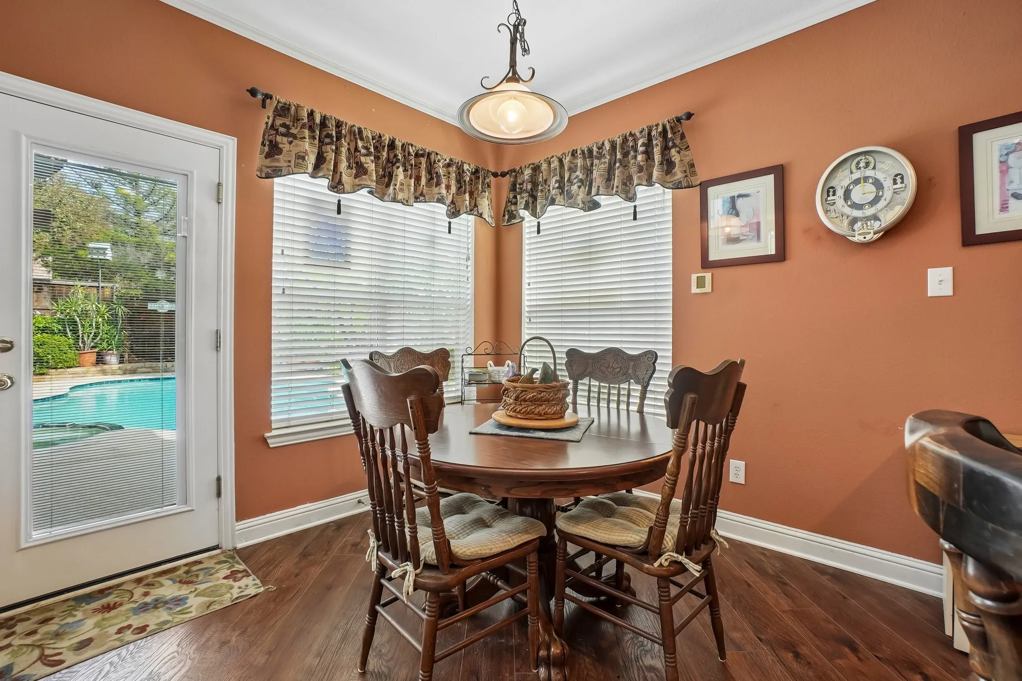 Wood-finish flooring with white baseboards