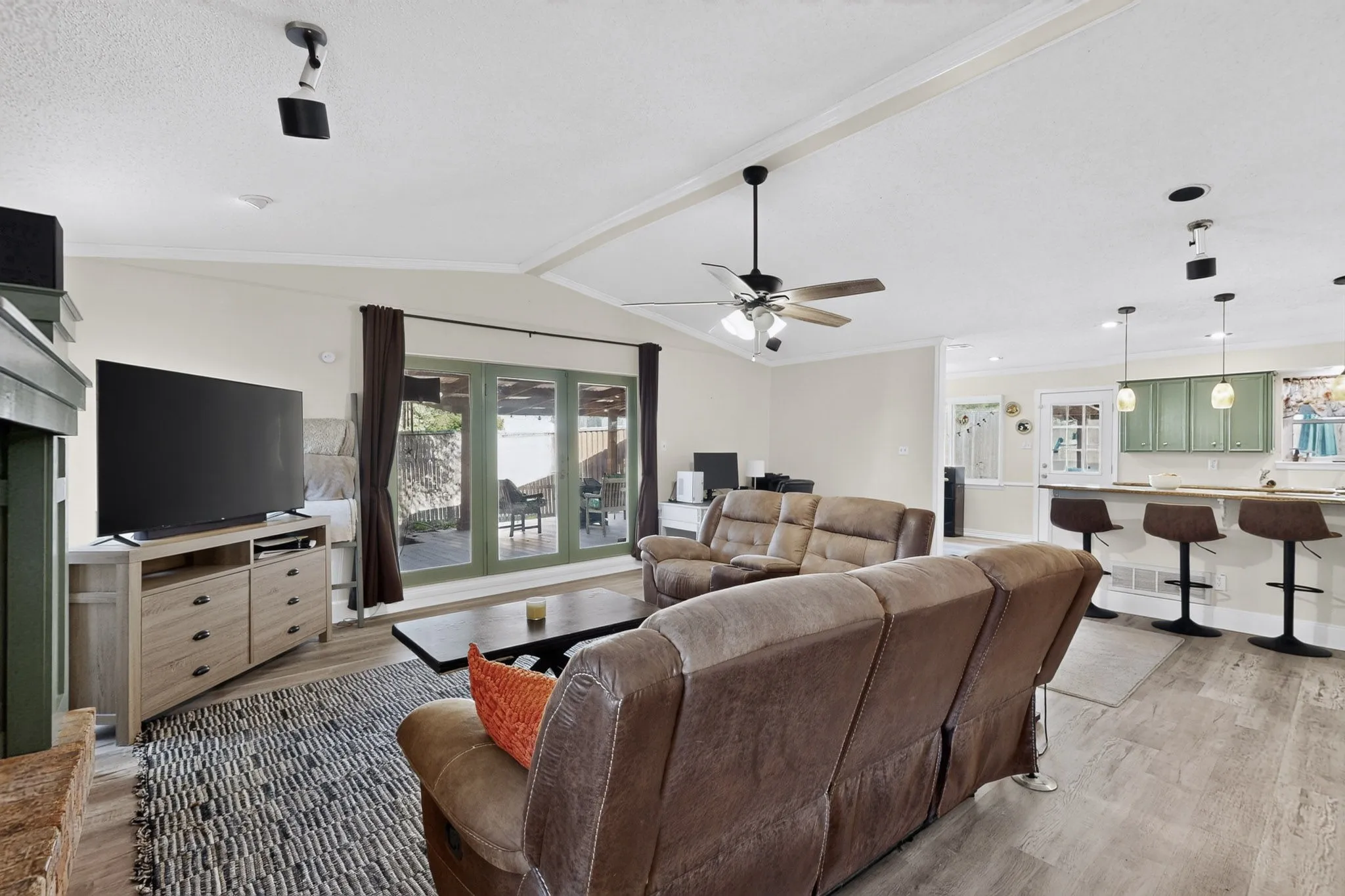 Vaulted ceiling with a ceiling fan, recessed lighting, wood-finish flooring, and French doors leading to an outdoor patio