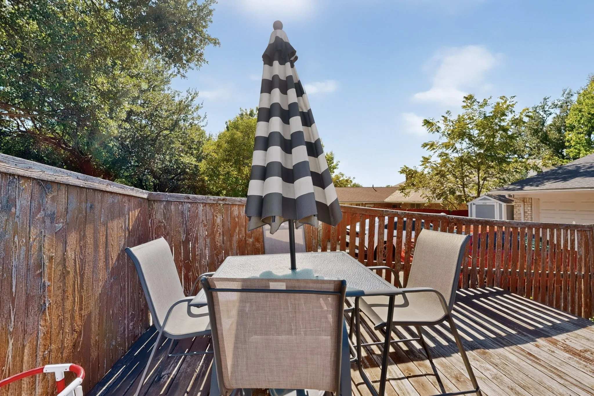 Wood-plank outdoor deck with perimeter fencing