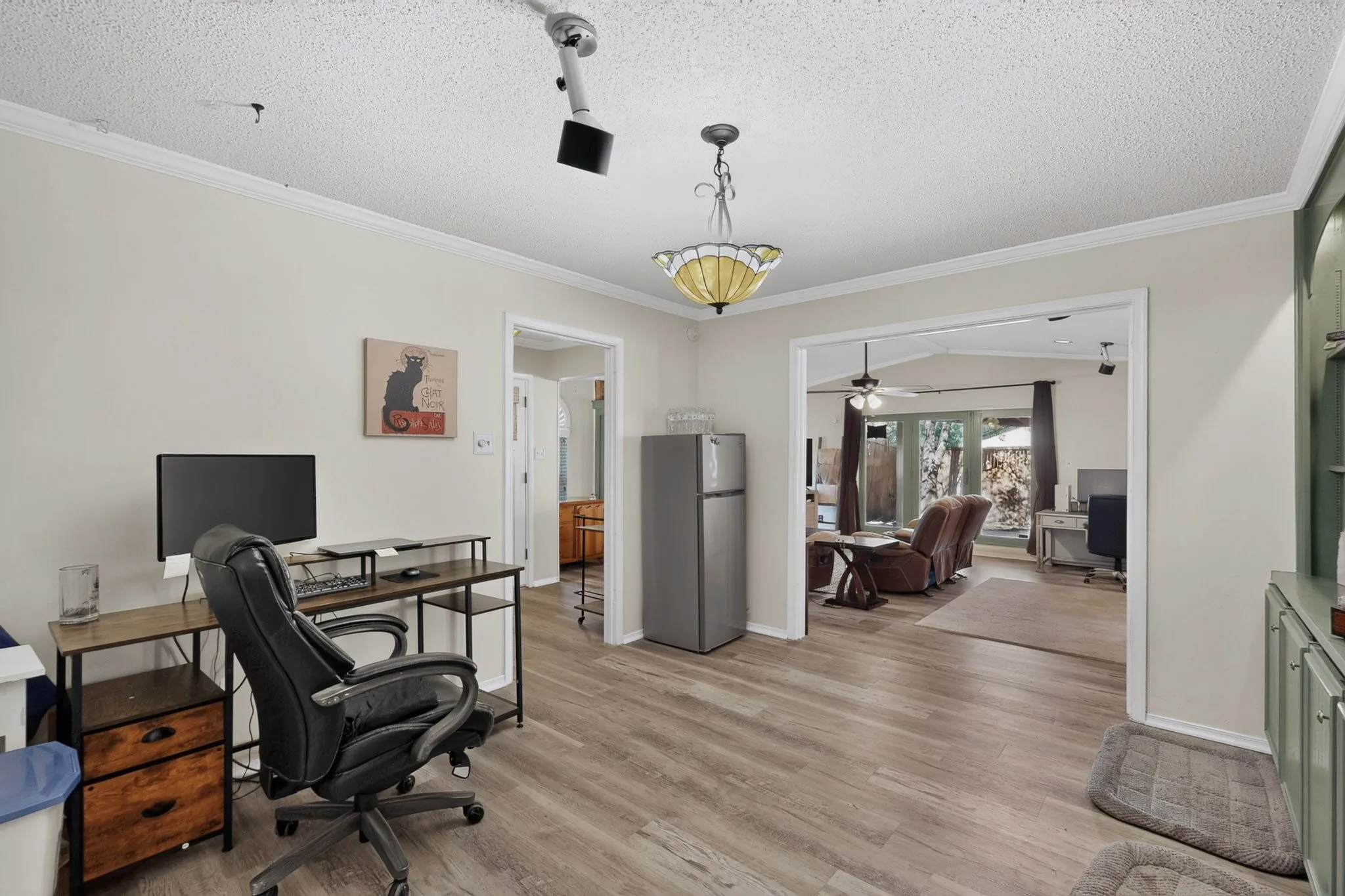 Wood-finish flooring, crown molding, and a built-in display cabinet