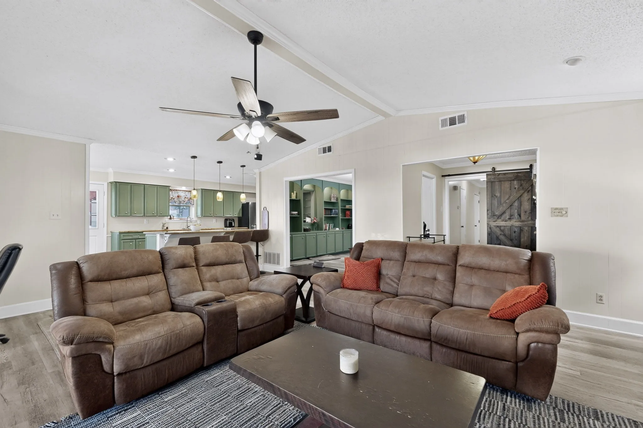 Vaulted ceiling with exposed beam, wood-finish flooring, recessed lighting, ceiling fan, and a built-in barn door
