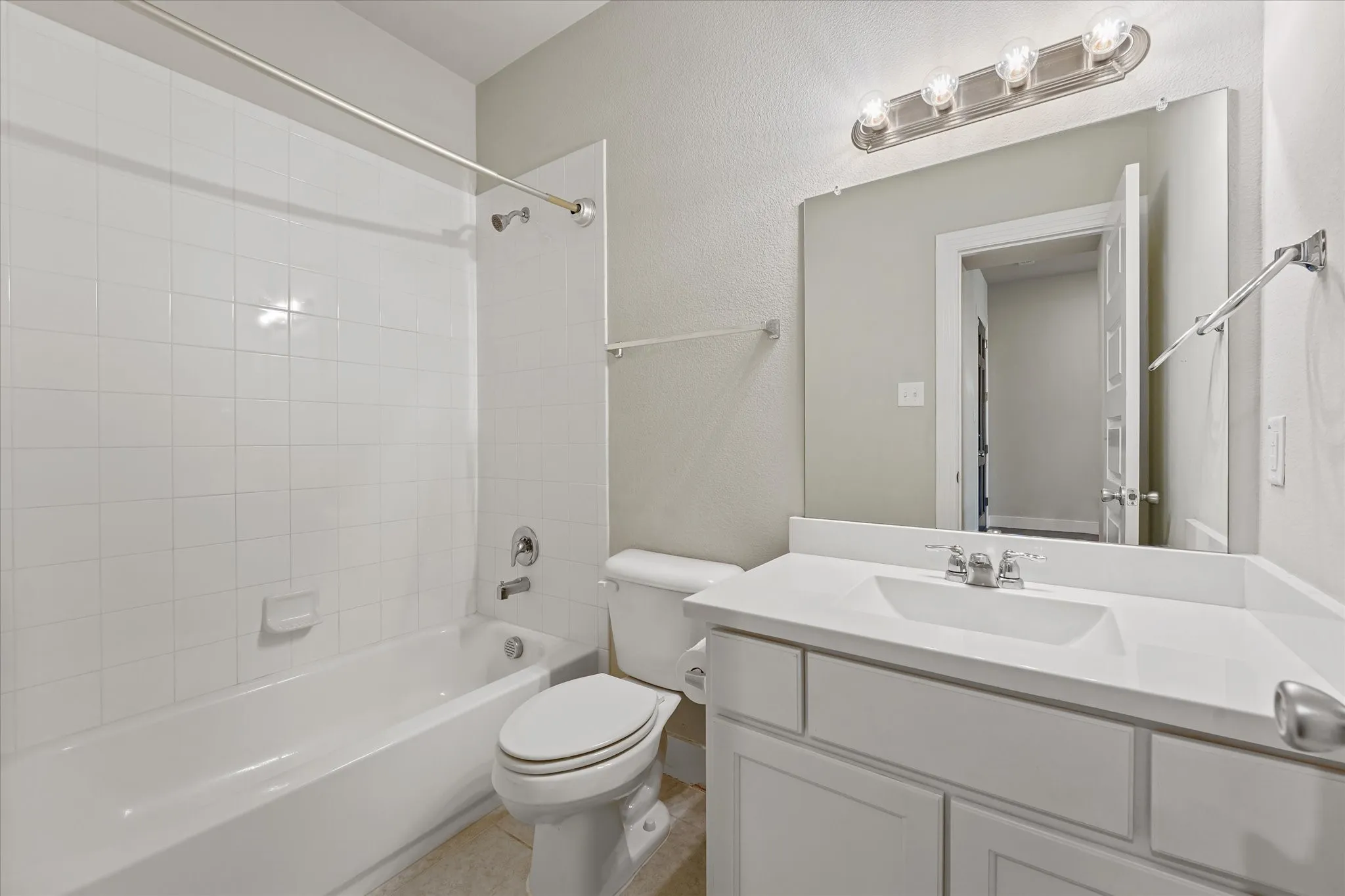 White vanity with integrated sink and chrome faucet