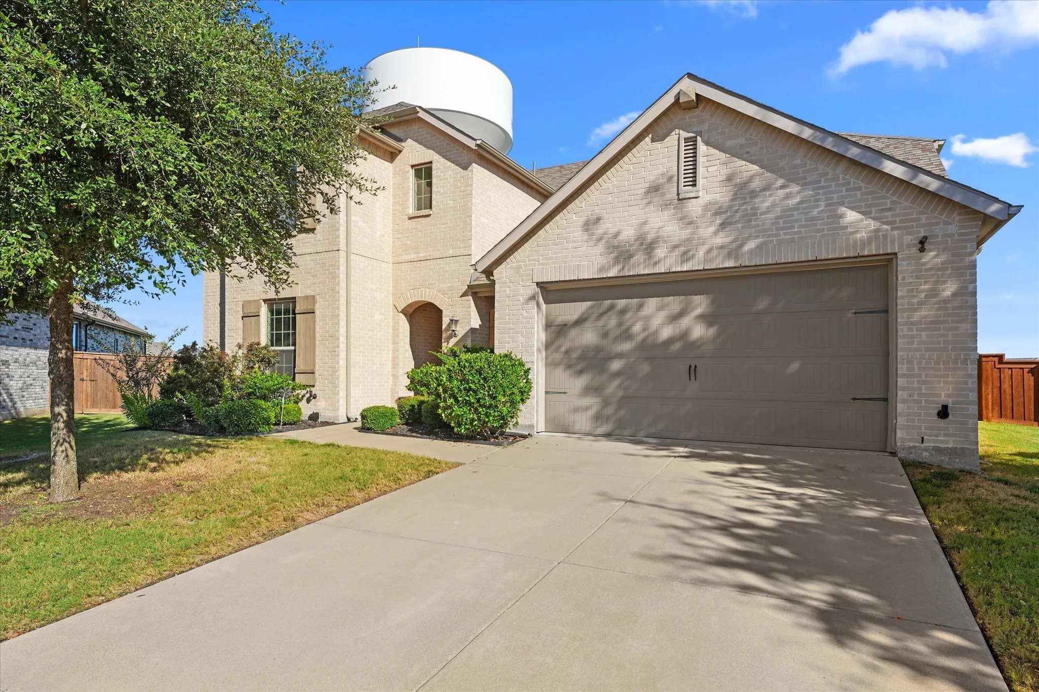 Brick exterior with a gabled roofline and attached two-car garage