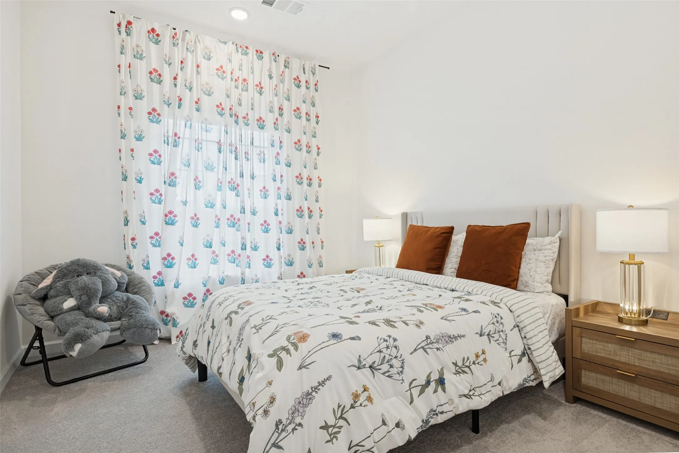 Recessed lighting, vaulted ceiling, light neutral wall color, window with sheer curtains, and plush neutral carpeting