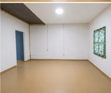 Recessed ceiling light with a wood-finish ceiling accent, neutral wall tones, and light-toned flooring