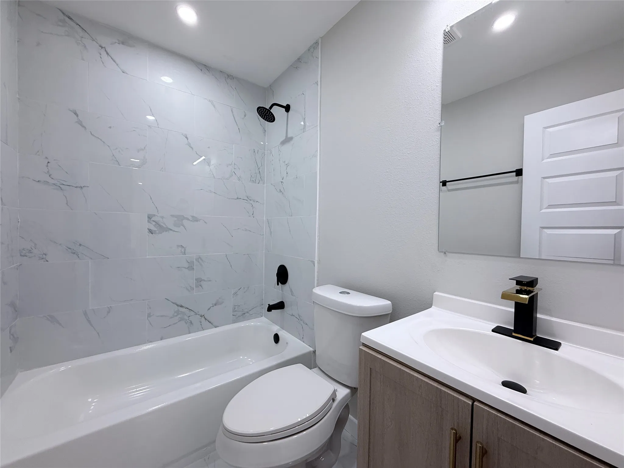 White tiled shower with black matte fixtures