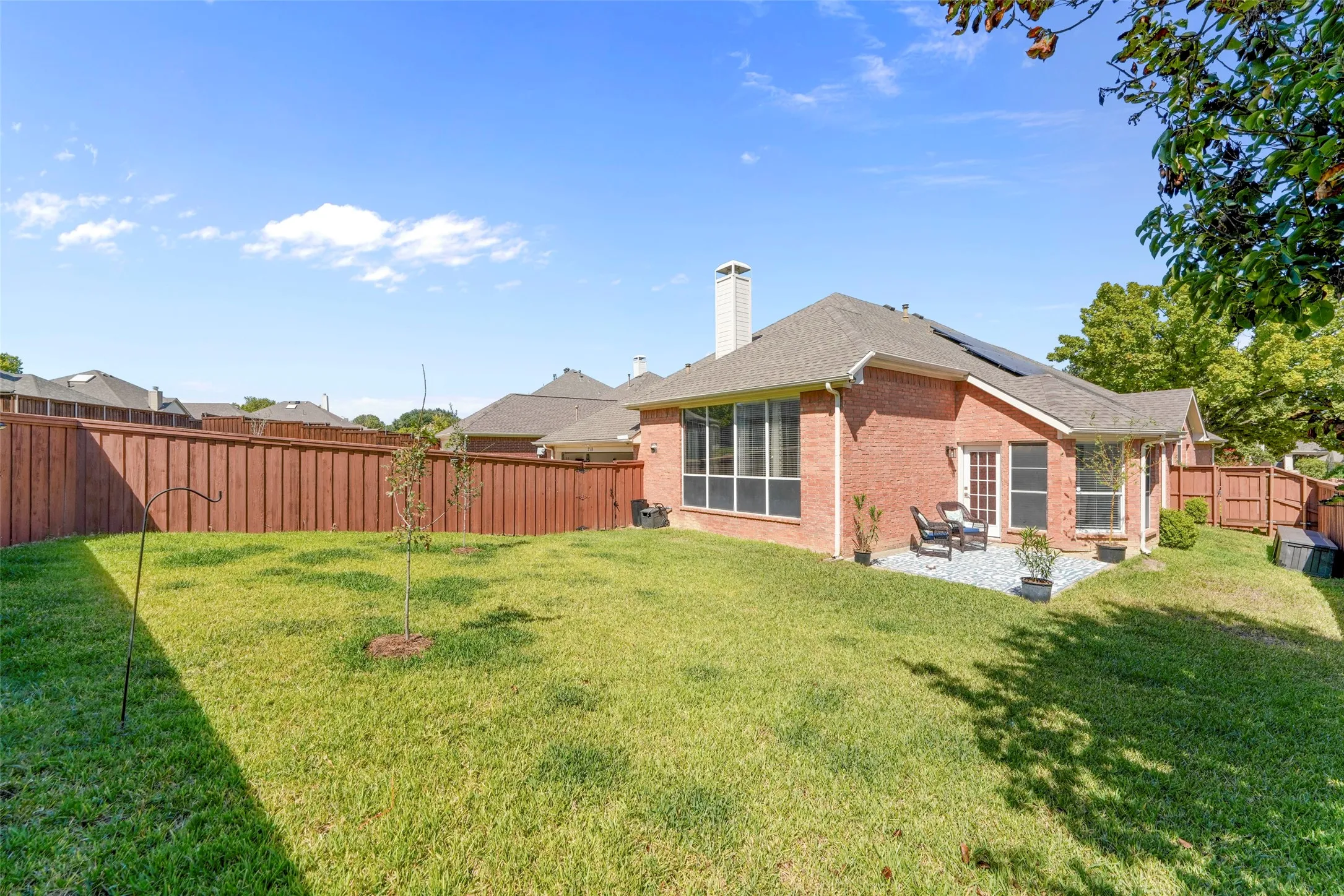 Wood privacy fence surrounds the large backyard