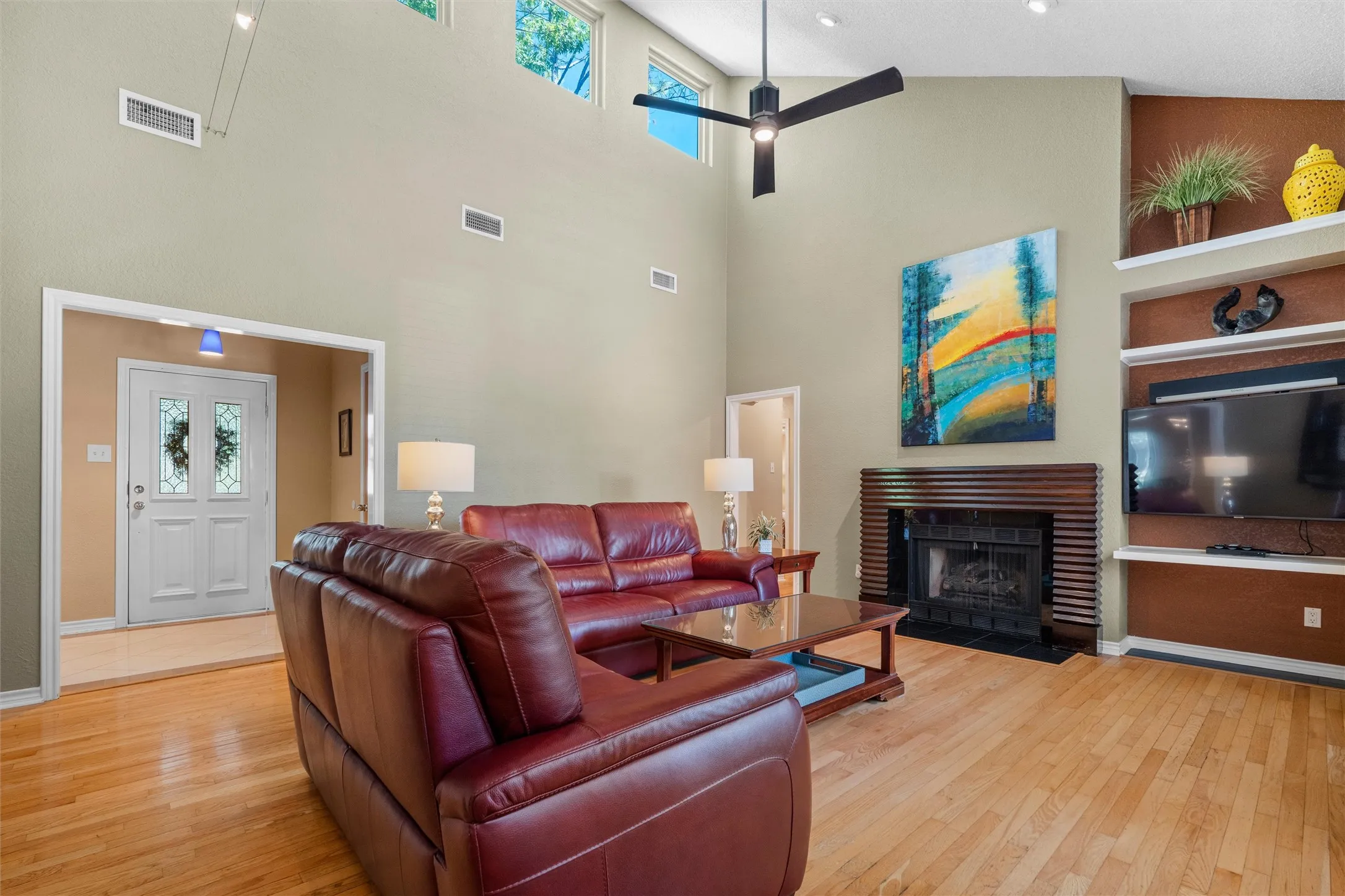 Large living area with vaulted ceiling and picture windows at the top.