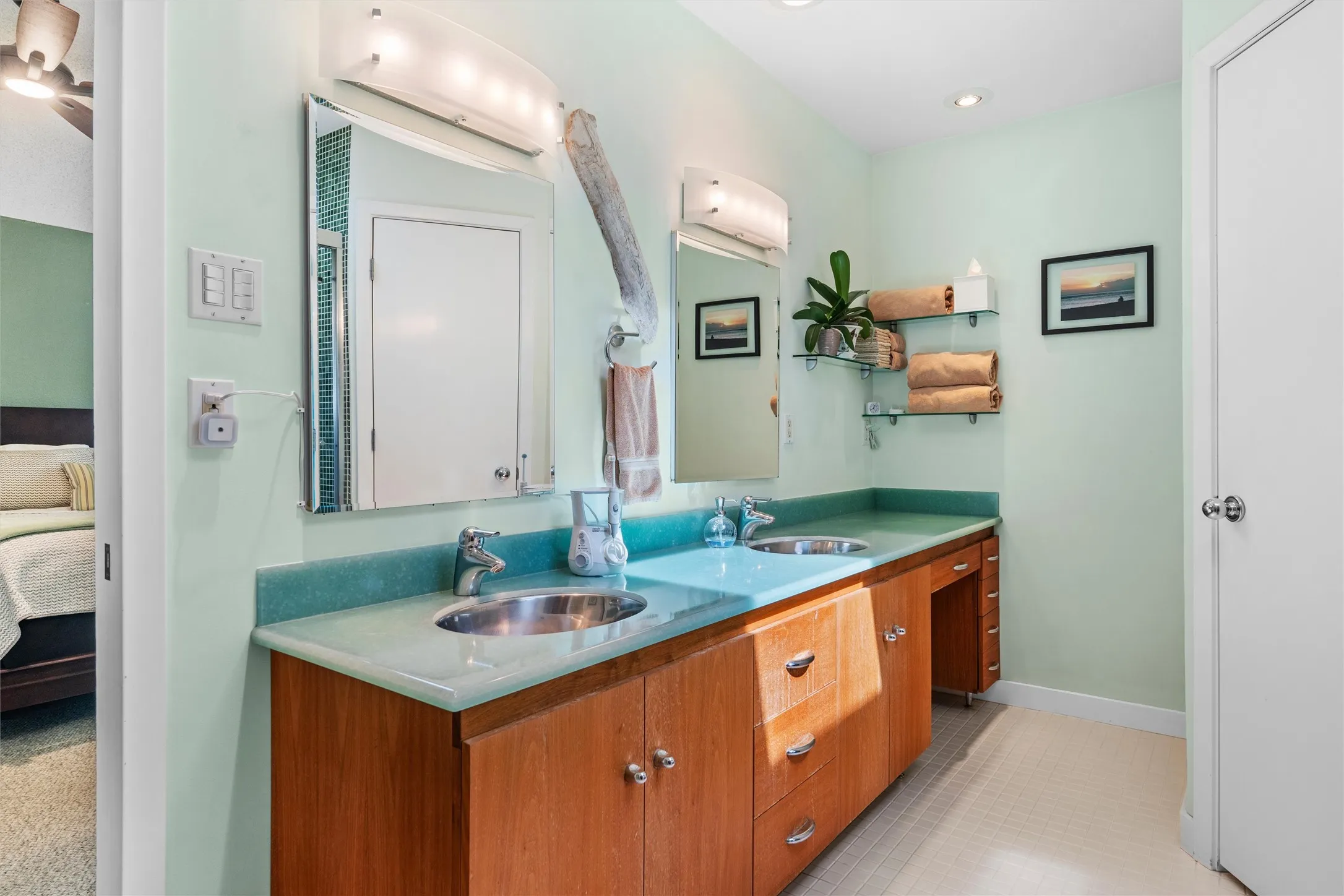 Custom designed primary bath with dual stainless sinks, counter top with vanity.