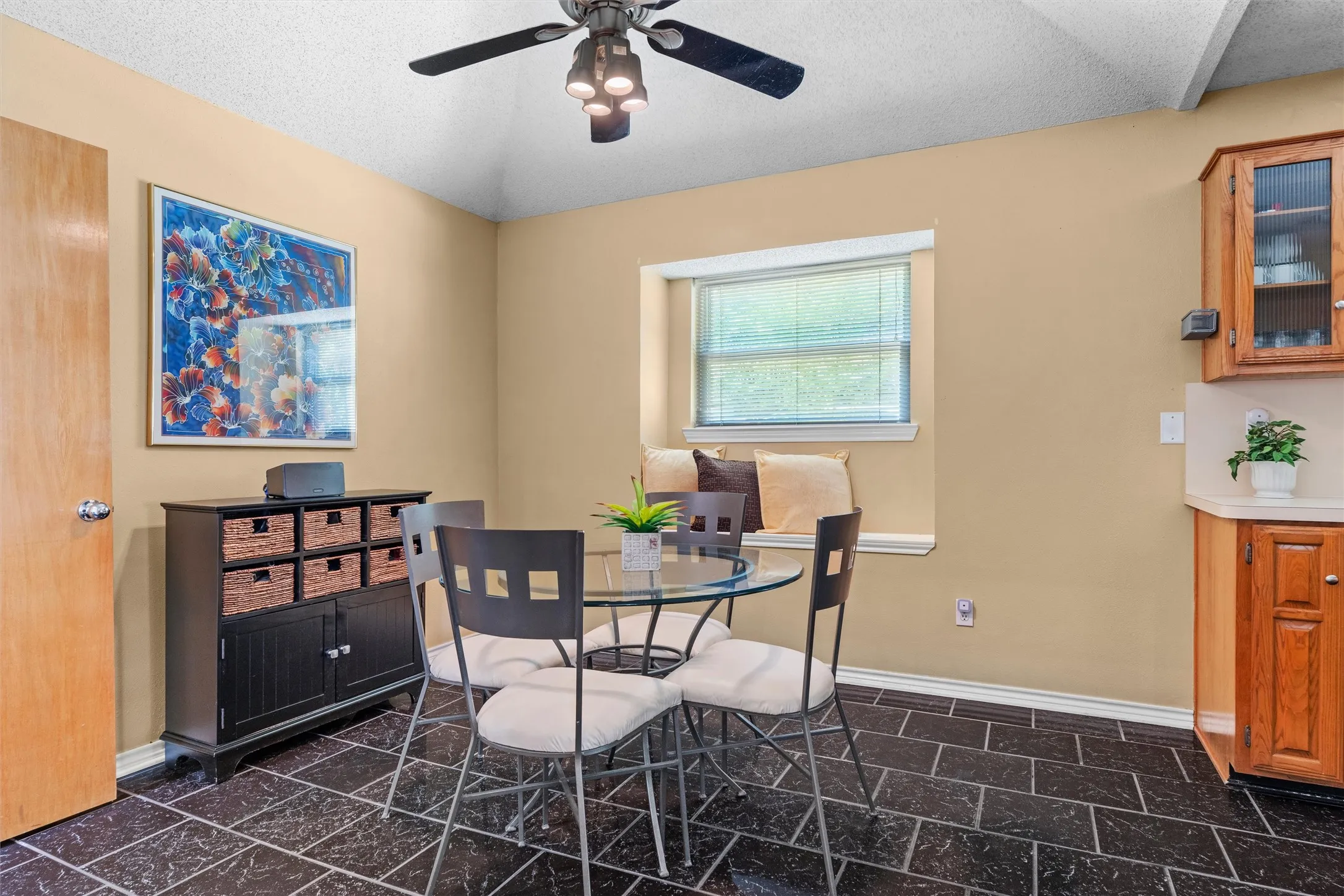 Another view of the eating area with window and bench seating.