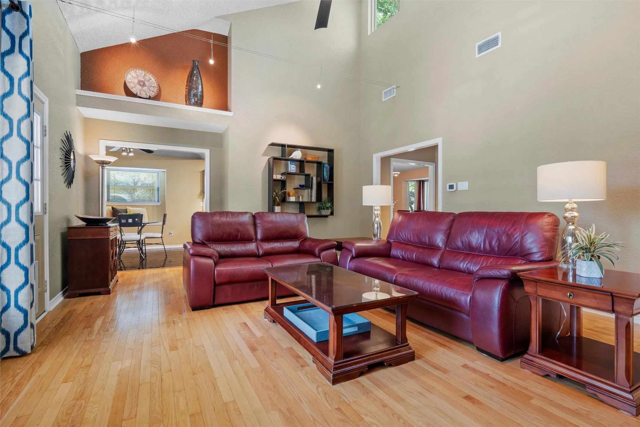 View of living area looking into the kitchen with art niche above the doorway.
