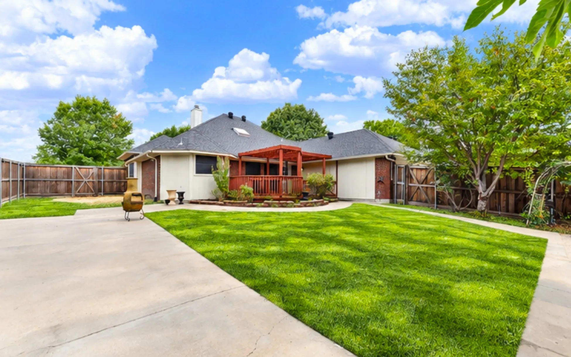 *digitally enhanced*  Clean rooflines and expansive concrete patio space encircle the central wooden deck, giving the entire rear elevation an inviting, open structure. Imagine setting up an outdoor lounge area where friends can spread out and enjoy lively summer weekend gatherings.