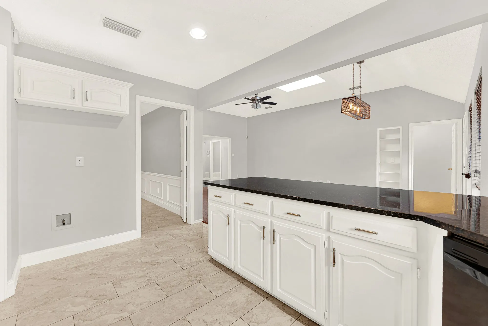 An expansive breakfast bar seamlessly bridges the cooking zone with adjacent living areas under high ceilings. Visualize family chatting over casual weeknight meals while prep work happens effortlessly nearby