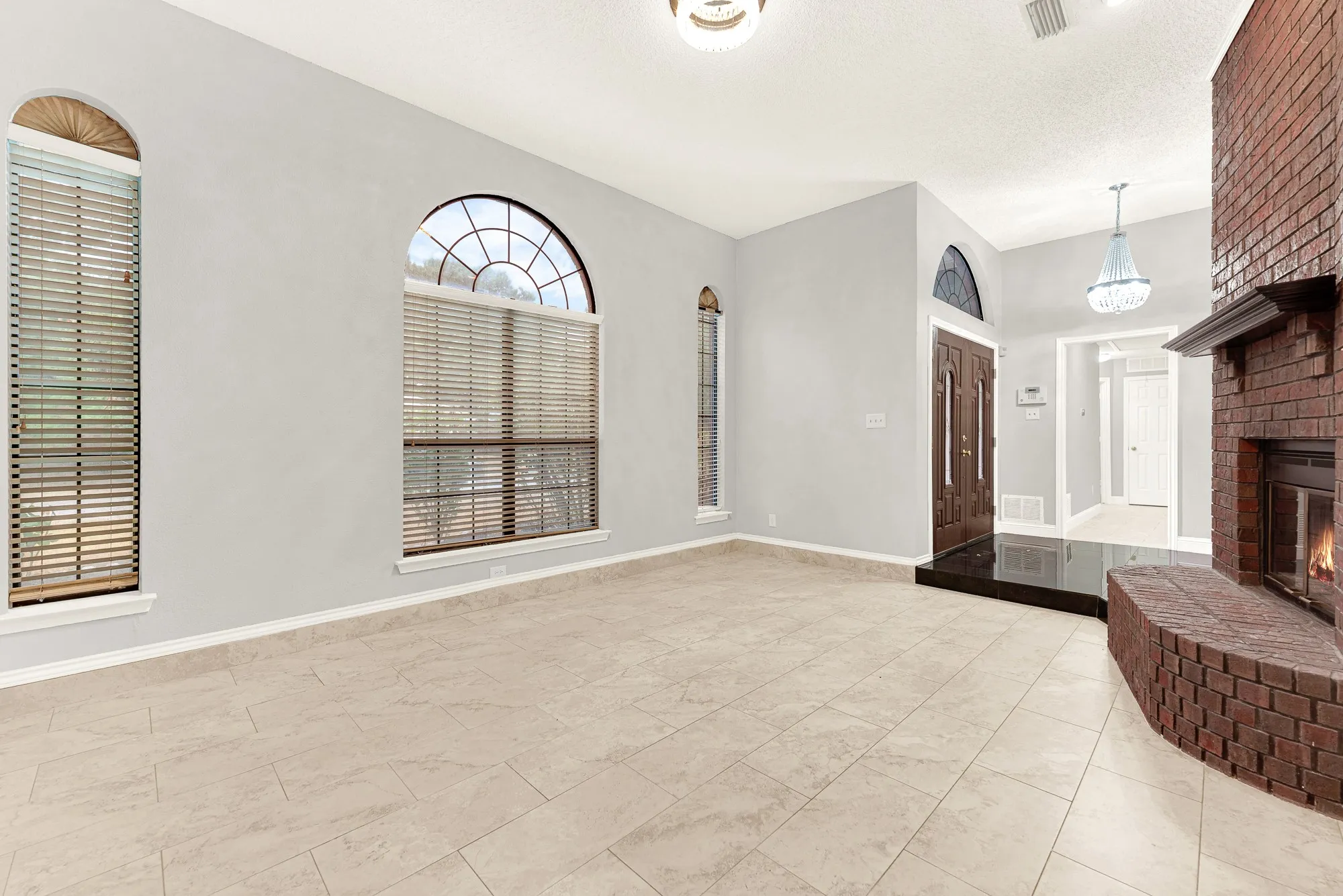 Sweeping tile floors reflect ambient light, effortlessly connecting the entry foyer to the main living area. You can easily envision welcoming guests through double doors for lively weekend dinner parties