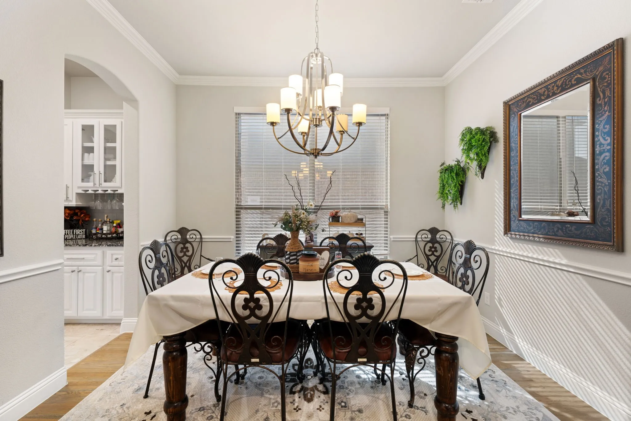 Formal dining space featuring crown molding, chair rail, and wood-finish flooring