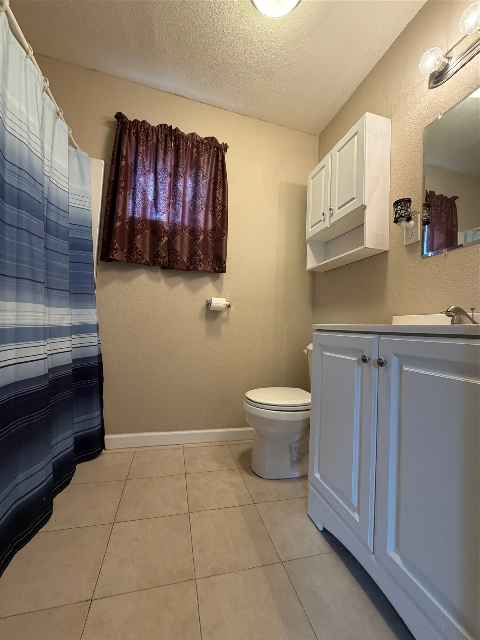 Tiled flooring with white baseboards