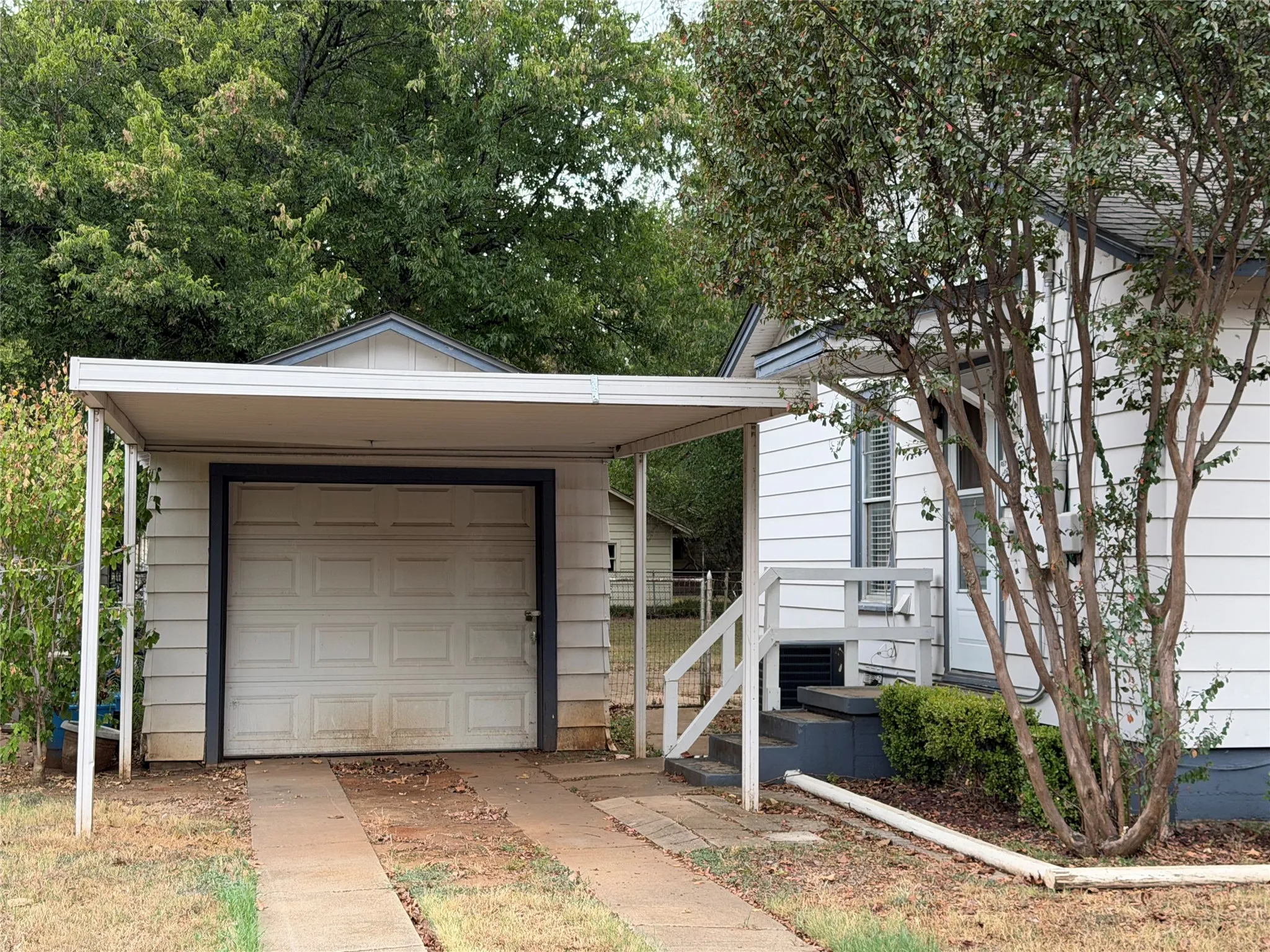 Attached carport with a single-car garage