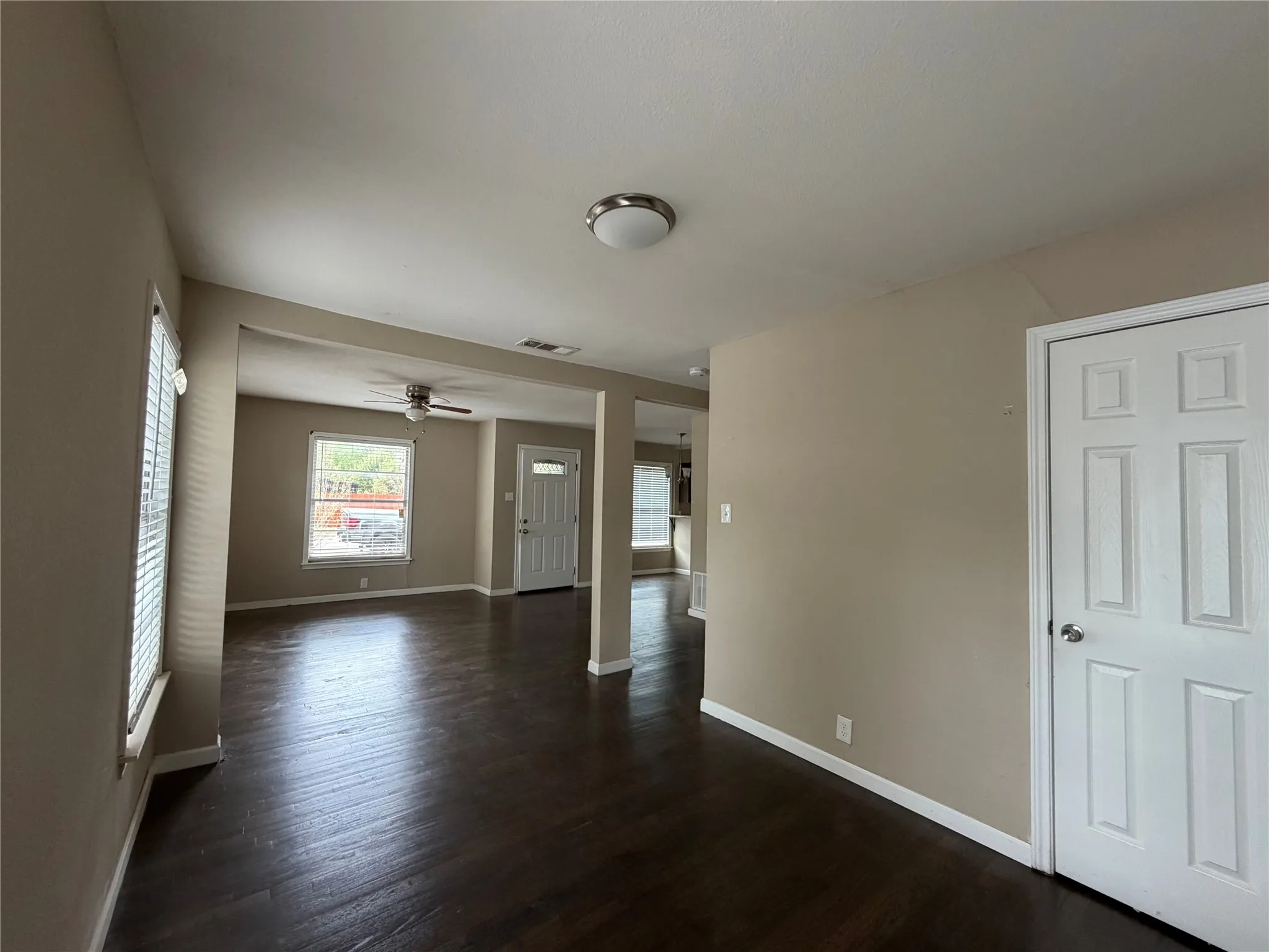 Wood-finish flooring throughout, neutral wall tones, and recessed lighting