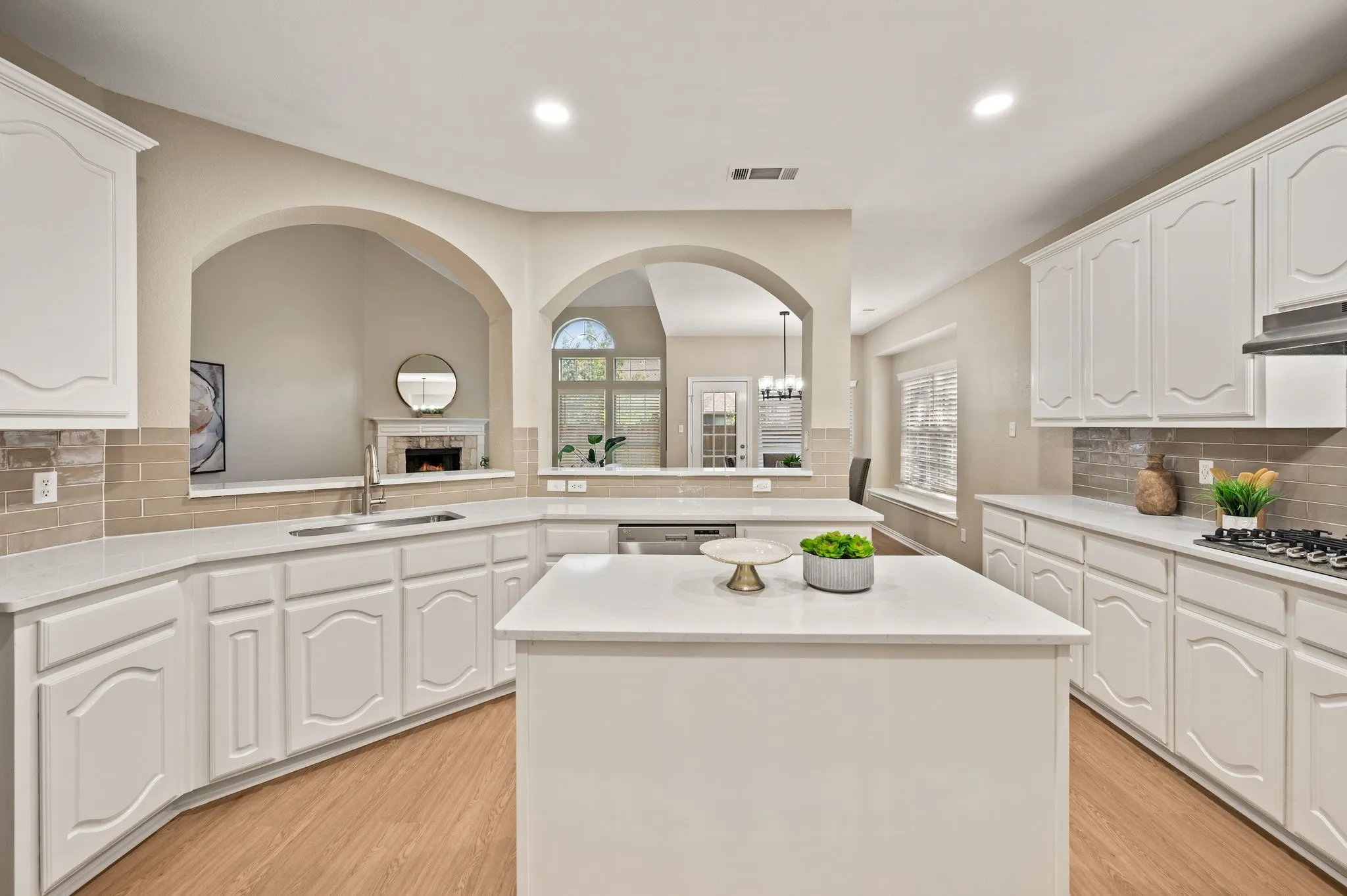Beautiful arched openings connect the kitchen to the living room, keeping the conversation flowing while you cook.