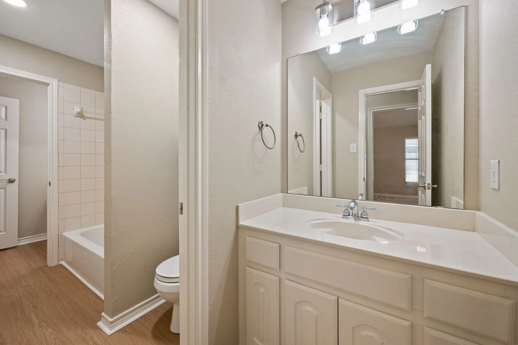 This secondary bath offers a generous vanity with cabinet storage & a separate tub-shower area for everyday convenience.